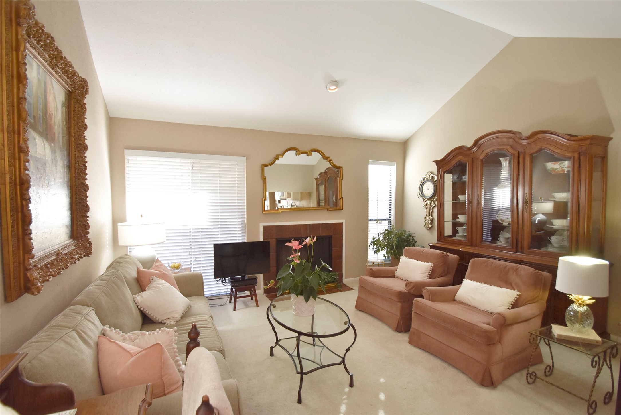 The cozy living are has a wood-burning fireplace and vaulted ceilings.