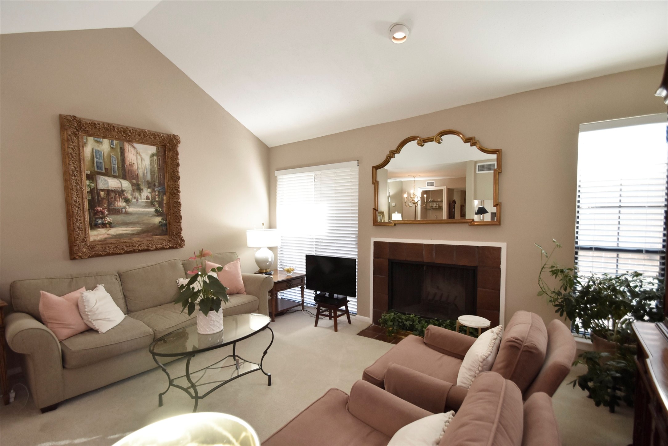 Another look at the terrific living area with a great amount of natural light and a wood-burning fireplace.
