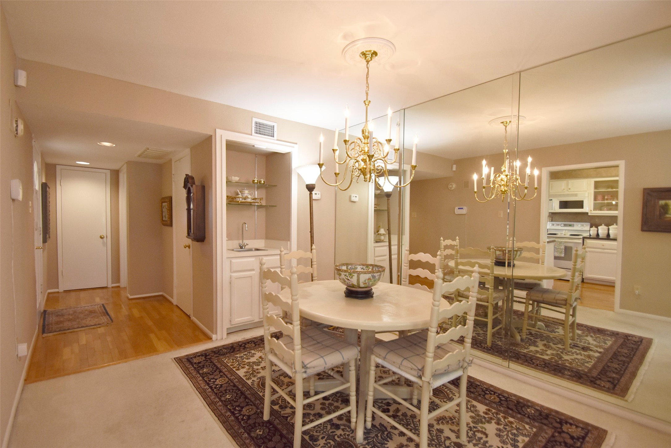The dining area is right by the kitchen and flows into the living area, There is a wet bar with shelving.