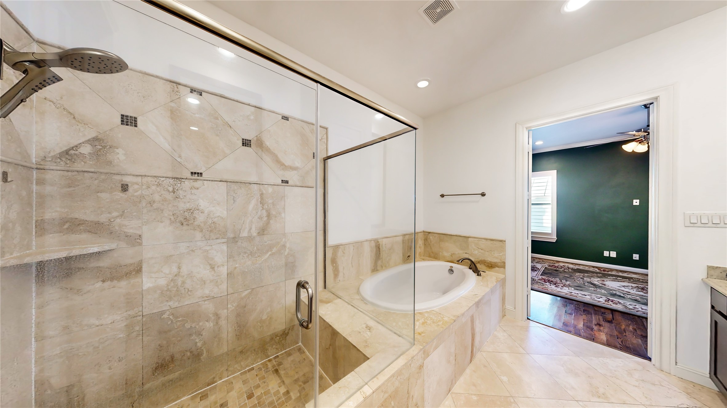 The primary bath is massive with a huge soaker tub and separate shower, two separate sinks, and a vanity area.