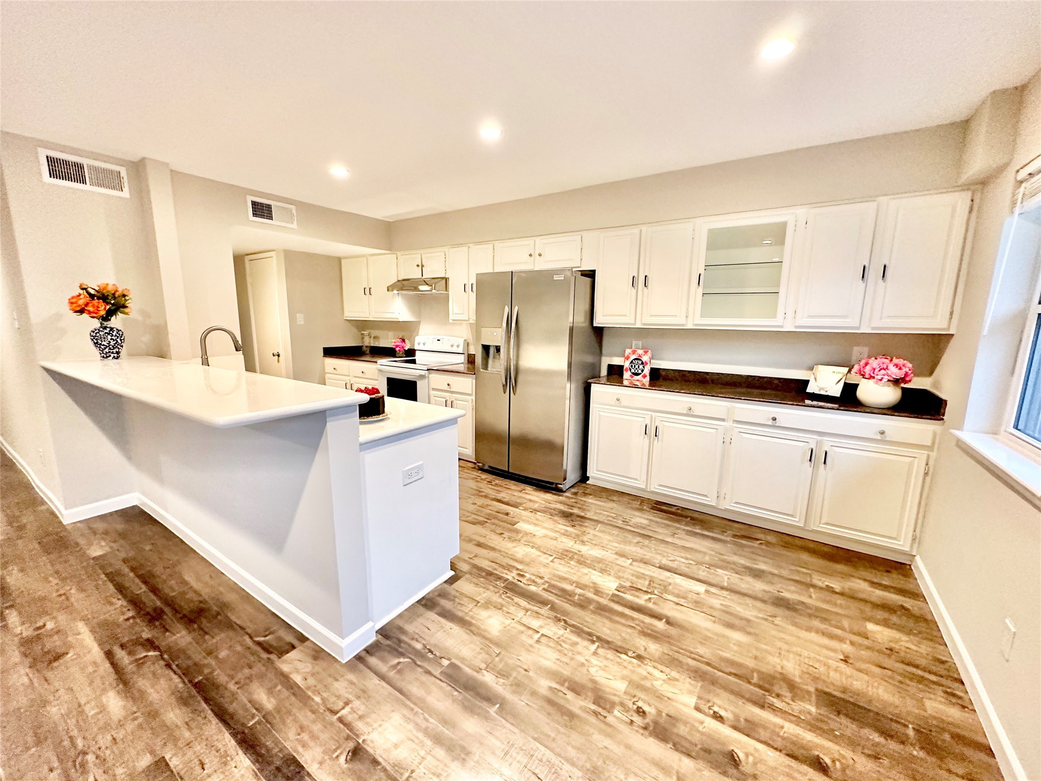 Updated kitchen has granite and white quartz counters that nicely complement each other.