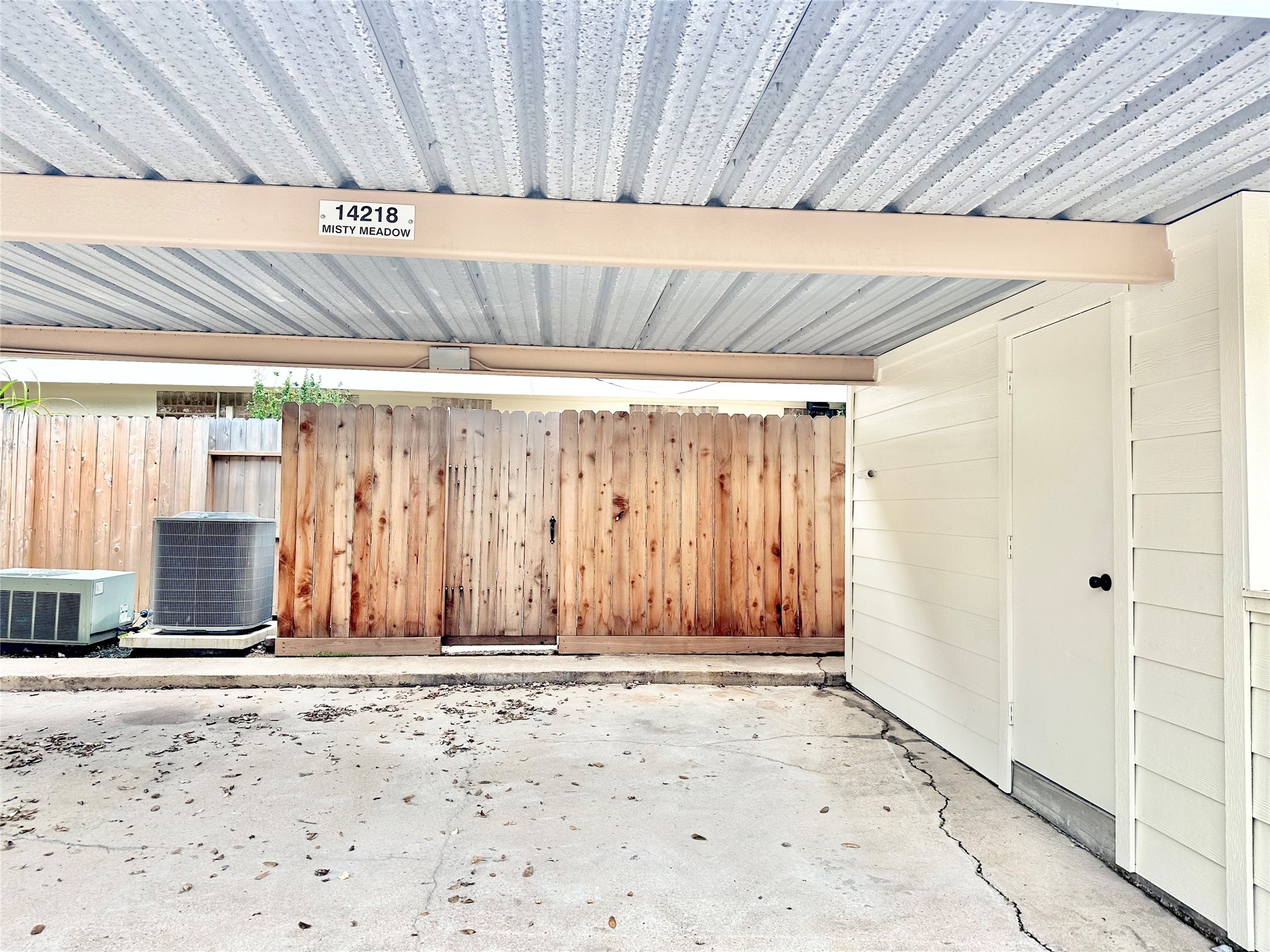 Your own 2 covered parking spaces which is only few steps to your back patio. Door on the right is your own storage area.