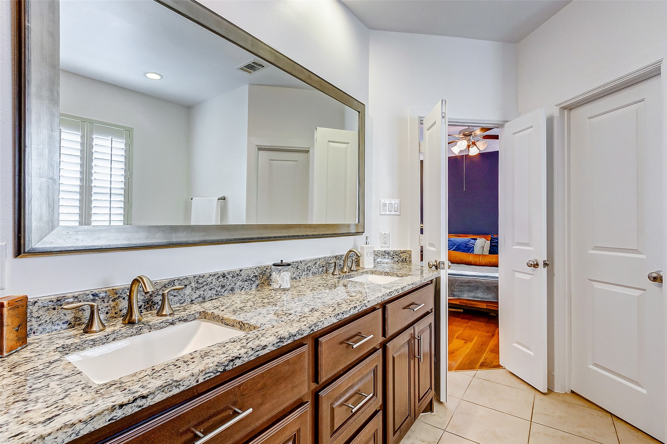 Alternate view of the spacious primary ensuite bathroom also offering a private water closet for plentiful privacy.