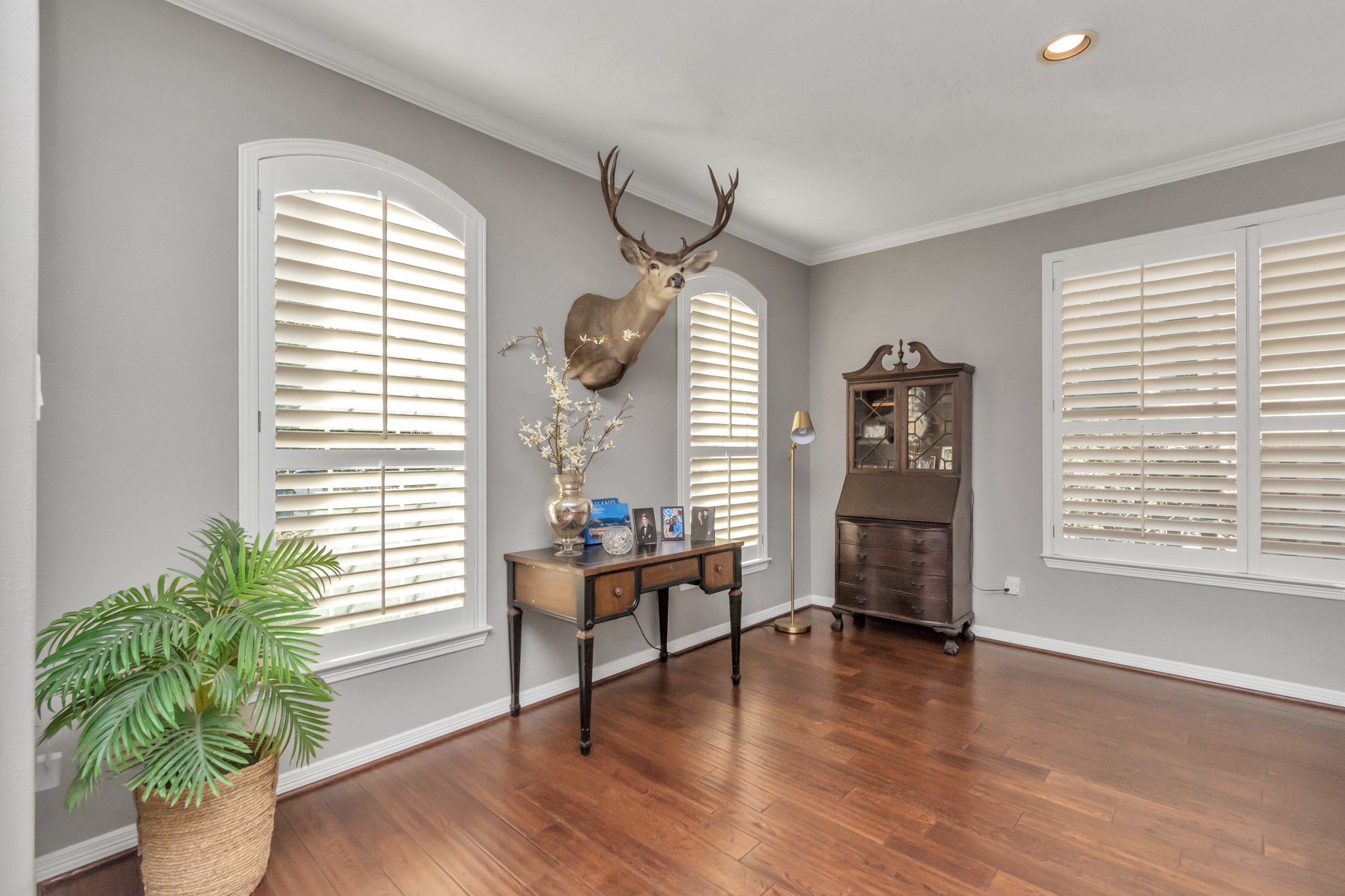 A significant perk of this home lies in the uniformity brought by the plantation shutters adorning each window.