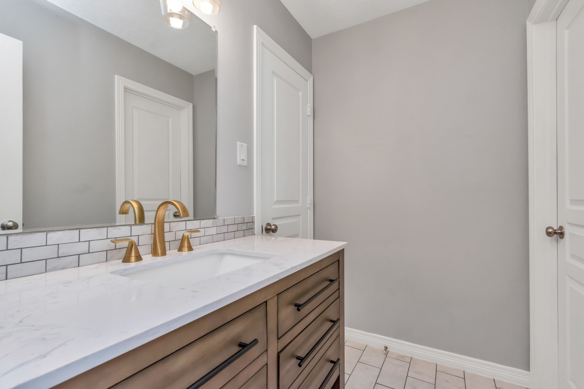 The Hollywood bathroom is conveniently accessible from both bedrooms and the hallway, offering ease of use and enhancing the layout of the home.