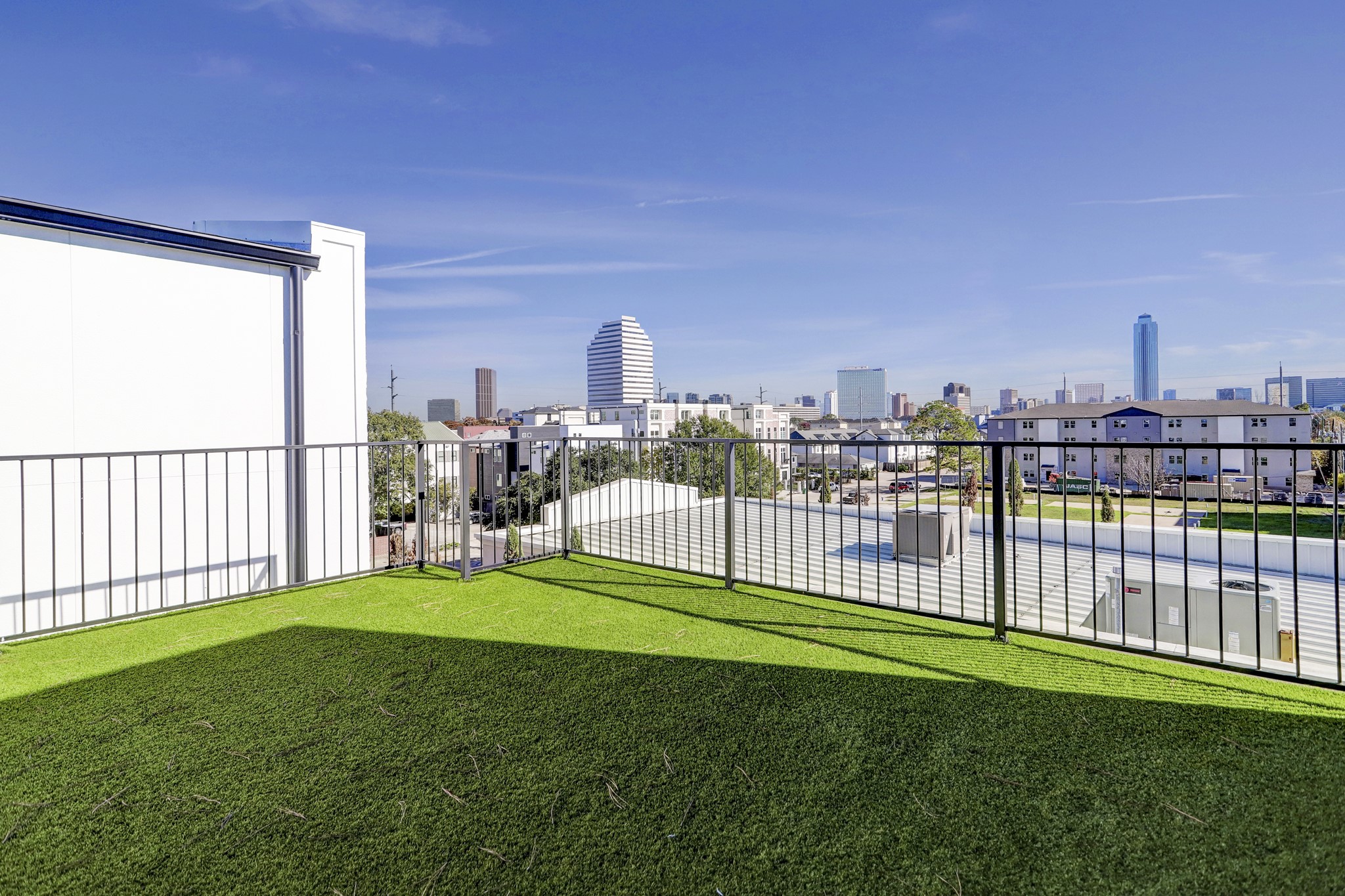 Stunning, turfed rooftop terrace offering city views.