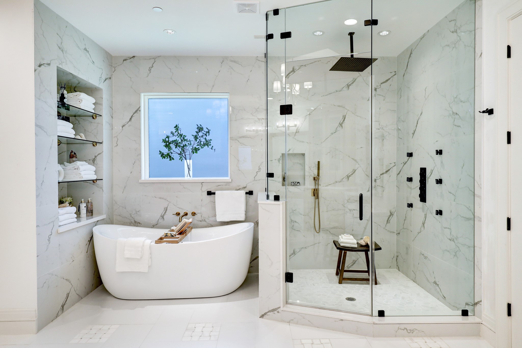 The primary bath features a bespoke walk-in shower with overhead rain shower, hand held sprayer and body jets. Deep standalone jetted, soaking tub...