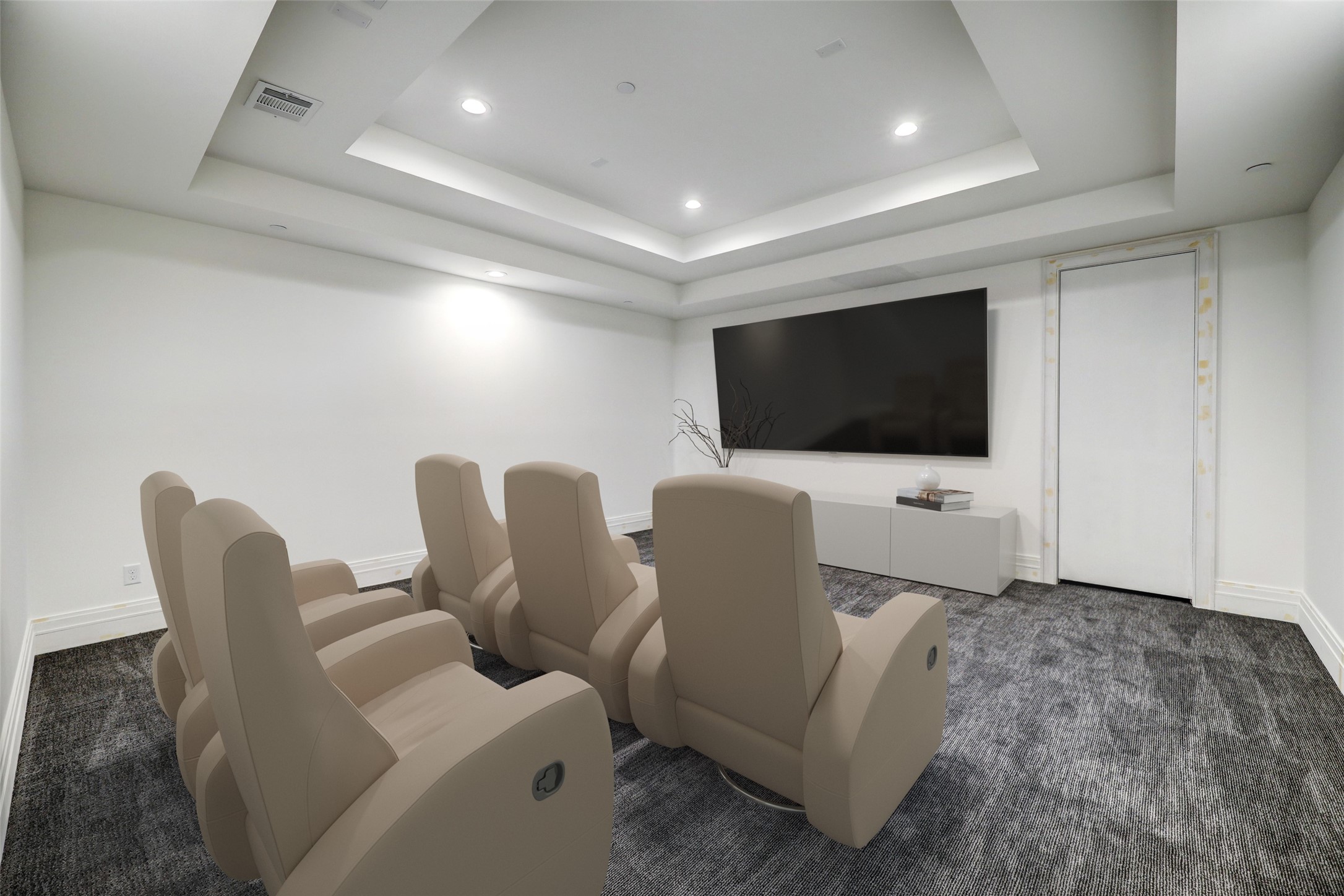 Virtually staged. Cozy media room with multi-stepped ceiling is perfectly location off the game room.
