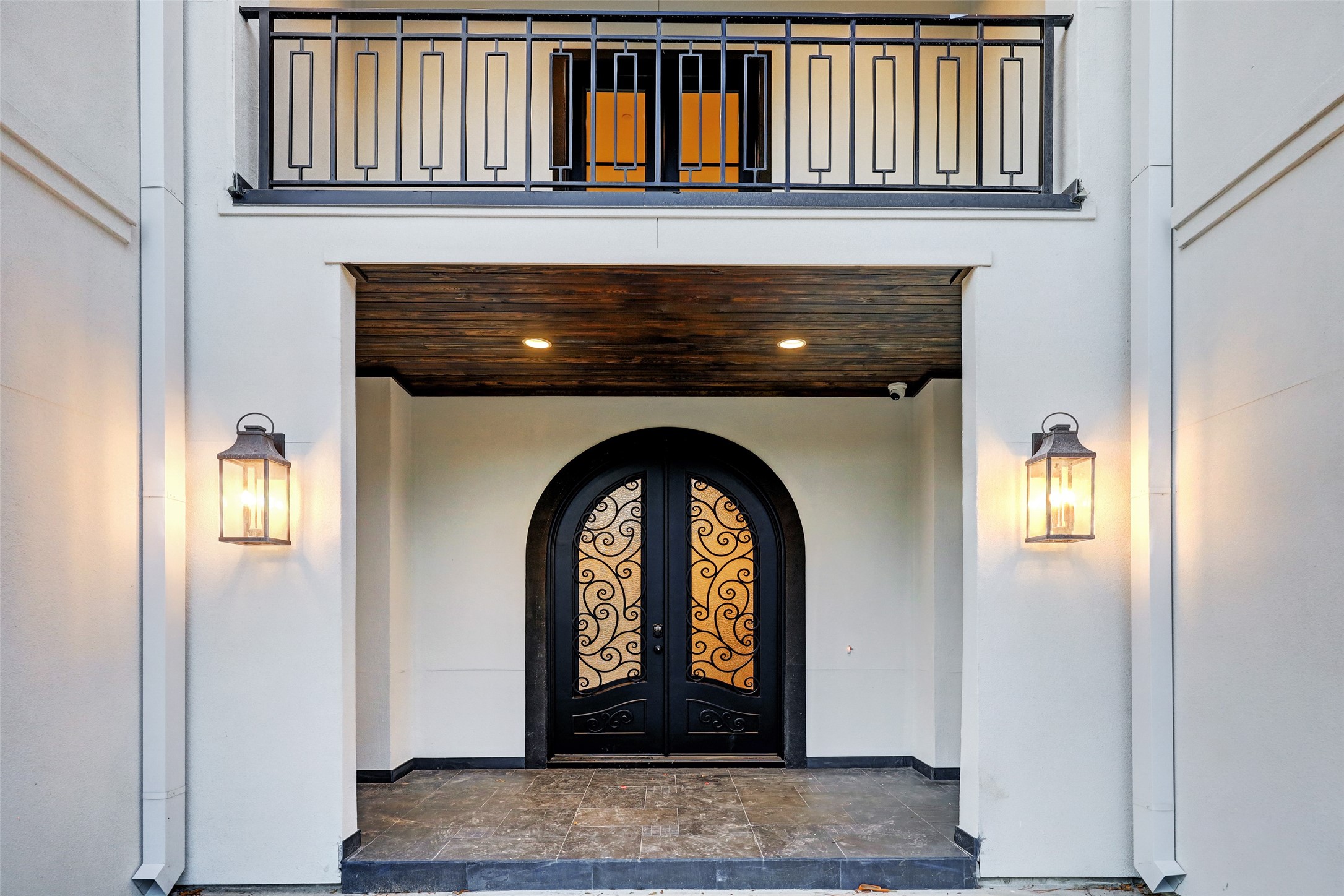 Vestibule entry with double doors and slate tiled floors, wood paneled ceiling, recessed and lantern lighting.