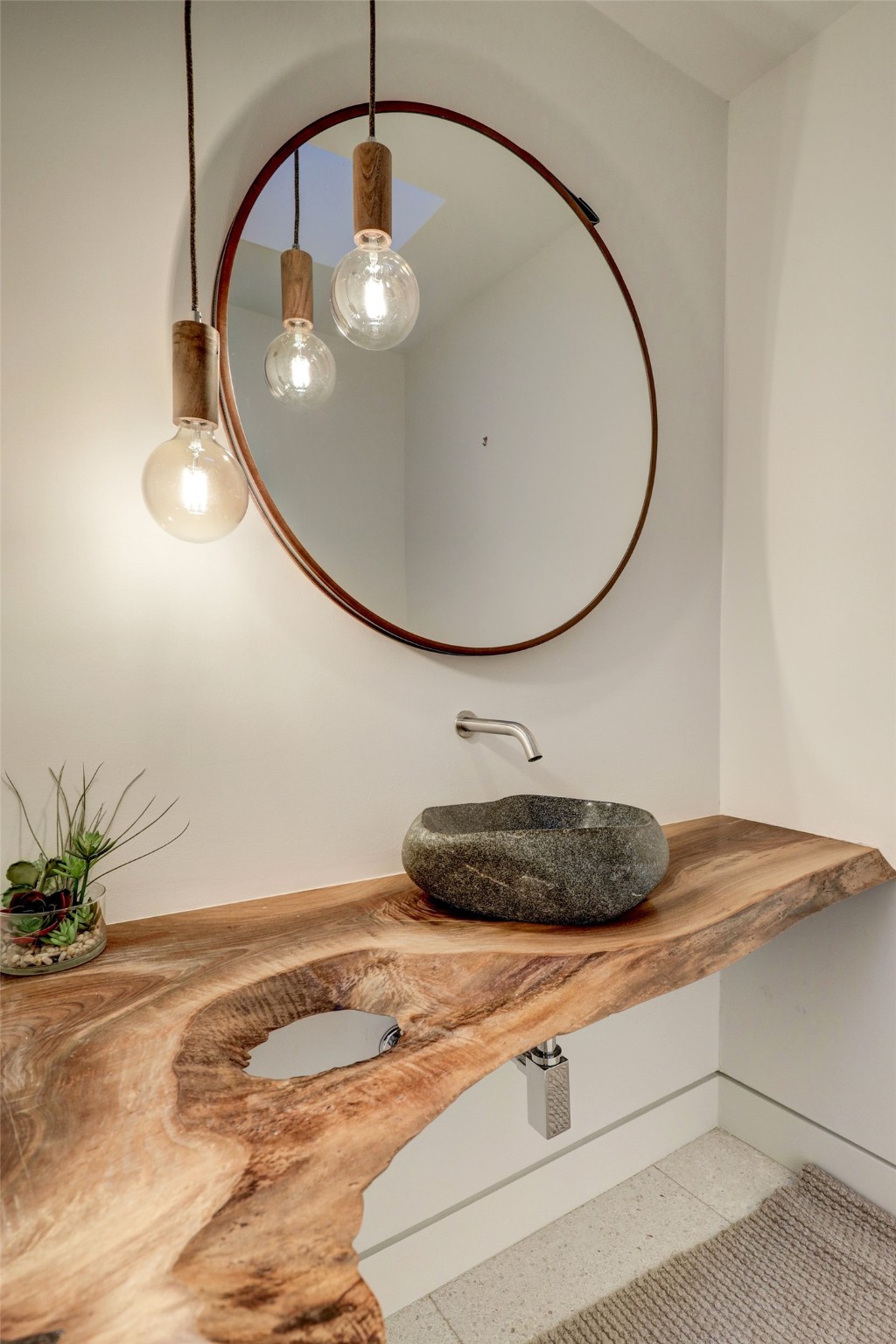 [En Suite Bath / Sink]
A single-piece of wood serves as the sink counter in the en suite bath. Note honed stone sink and wall-mount faucet.
