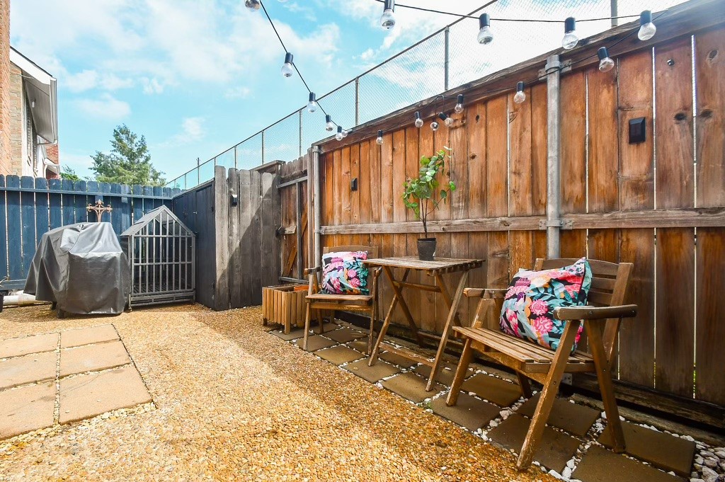Large fenced in patio is perfect for a grill and some outdoor furniture! 
!