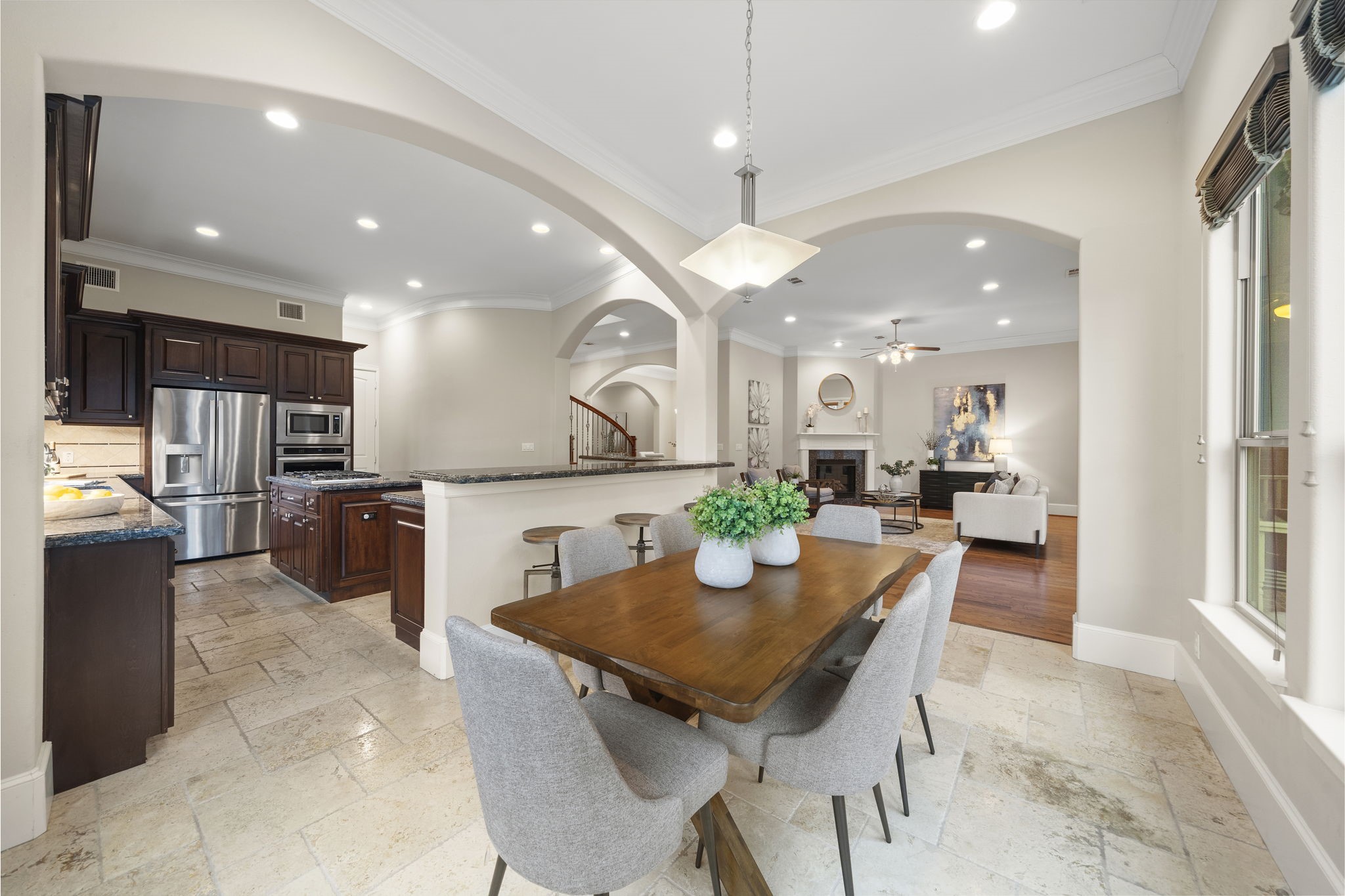 Prepare meals with ease in the open kitchen with two breakfast bars, a vast island, a breakfast nook, and a convenient layout that provides easy access to the dining and living areas.