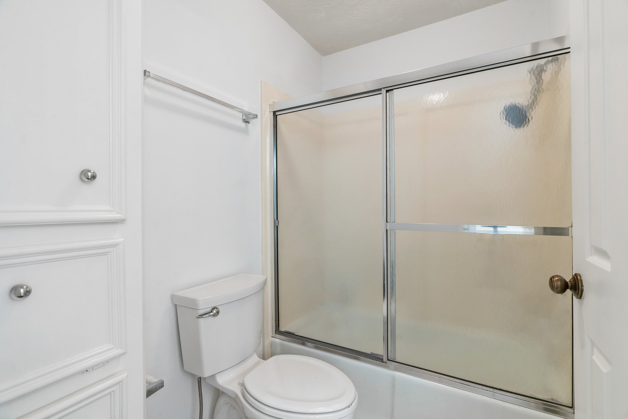 Shared bath glass enclosed tub/shower.