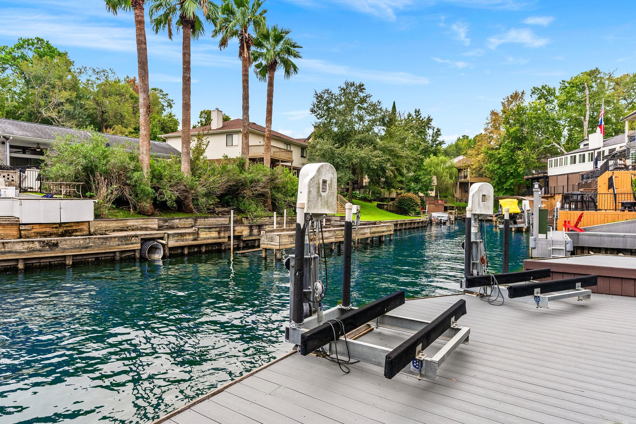 The two jet ski lifts swing around to electrically lower into the water then sit on deck for easy access to clean when finished playing in the lake!