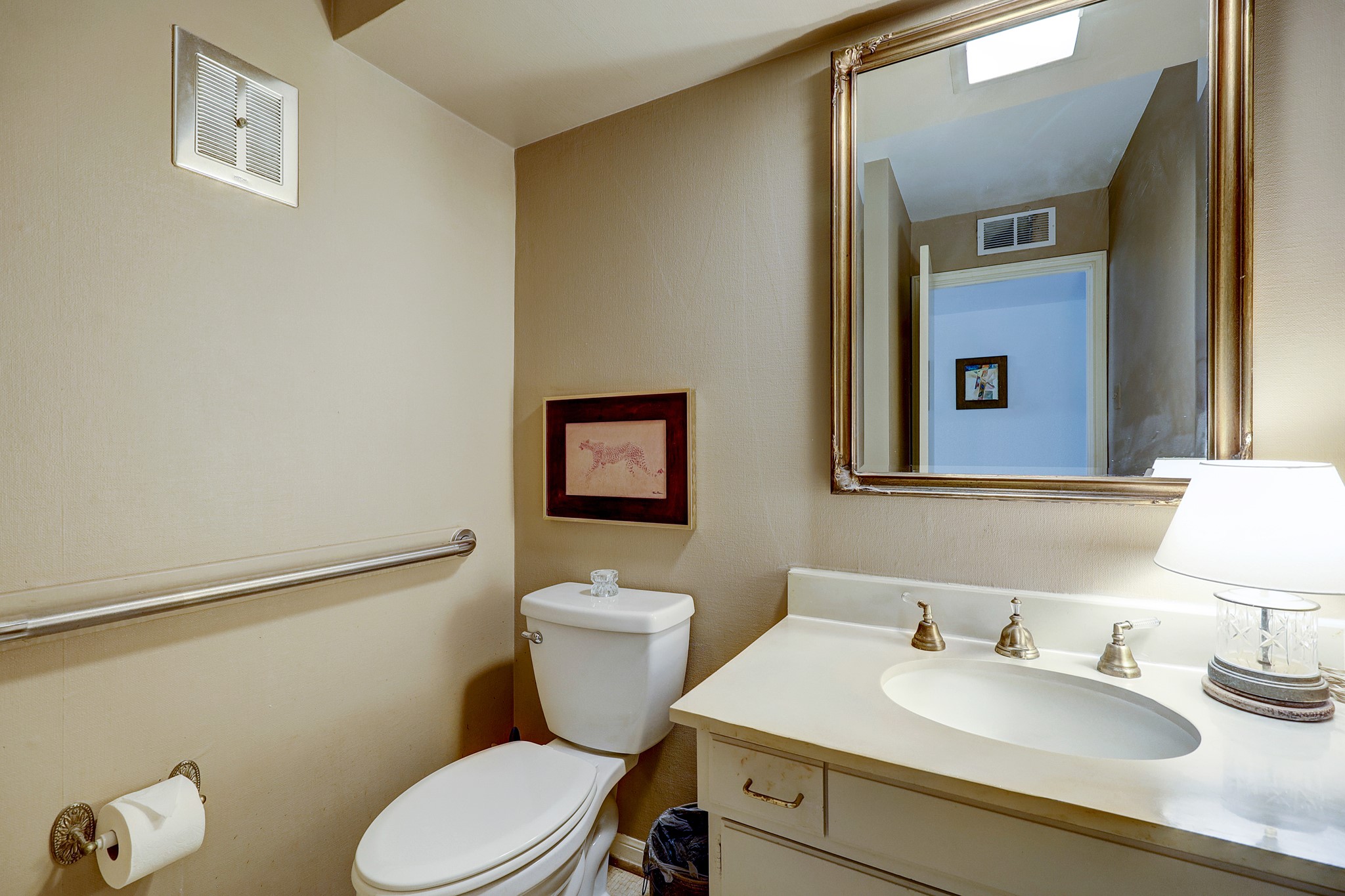 The downstairs half bath is conveniently located near the dining room and kitchen for easy access. In the downstairs hallway, there is an abundance of storage, including an elevator capable closet. The utility room is also featured downstairs as well.