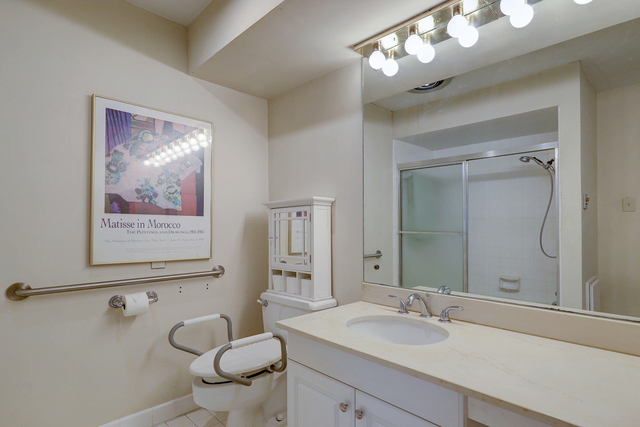 One of two en-suite primary bathrooms! Featuring plenty of counter space, under sink storage, a sizable shower/bathtub combo, and bright lights above the mirror.