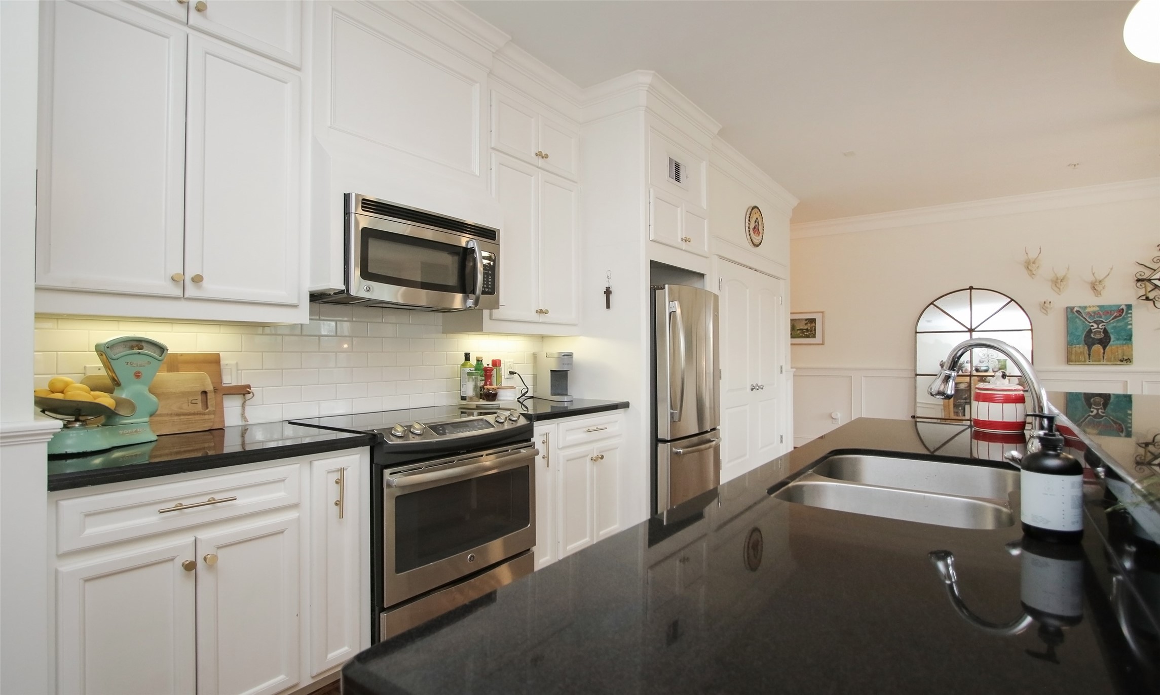 Notice all of the gleaming granite counter space. There is also a large double door pantry.