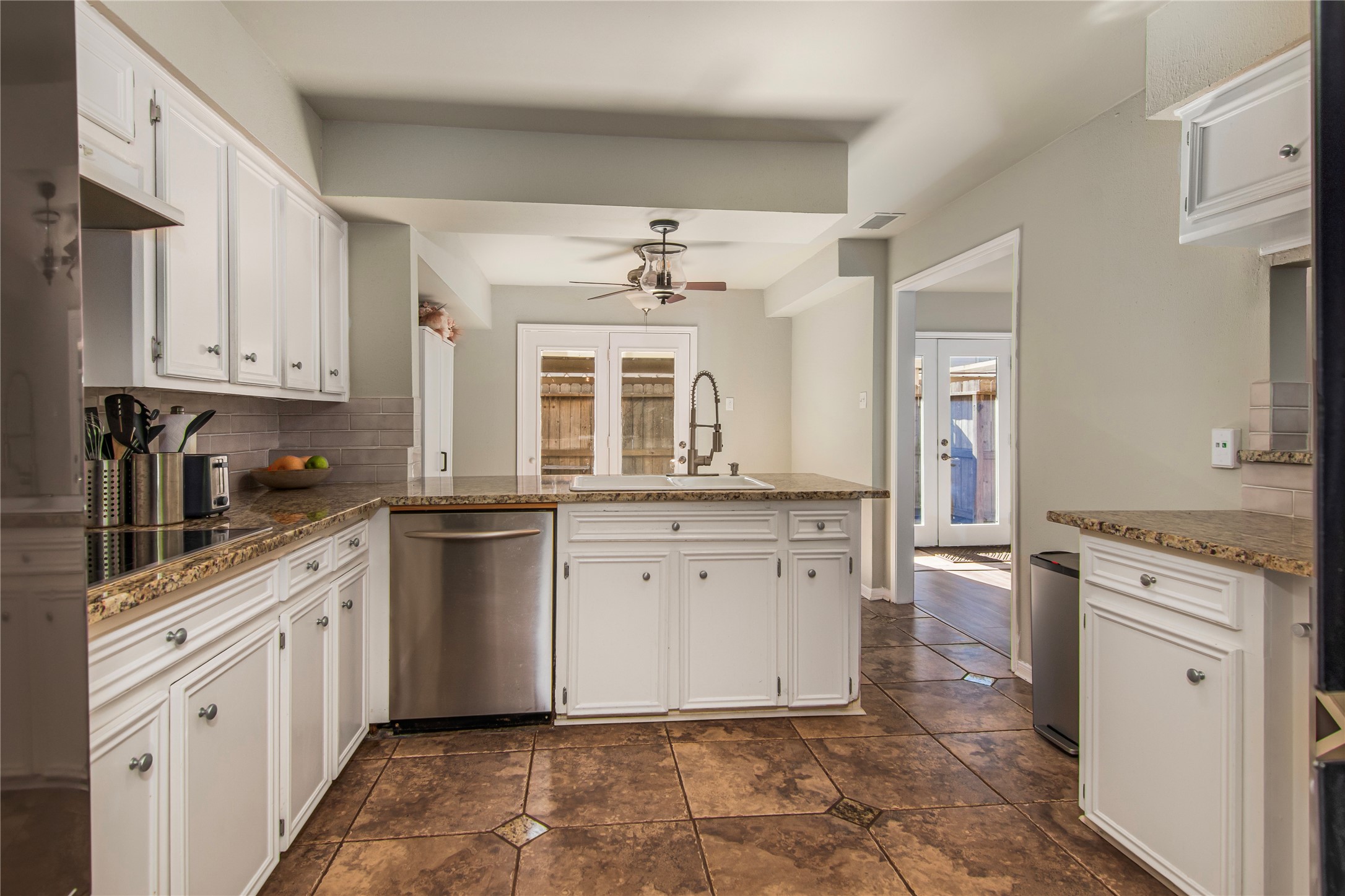 Kitchen with granite countertops and tiled floors