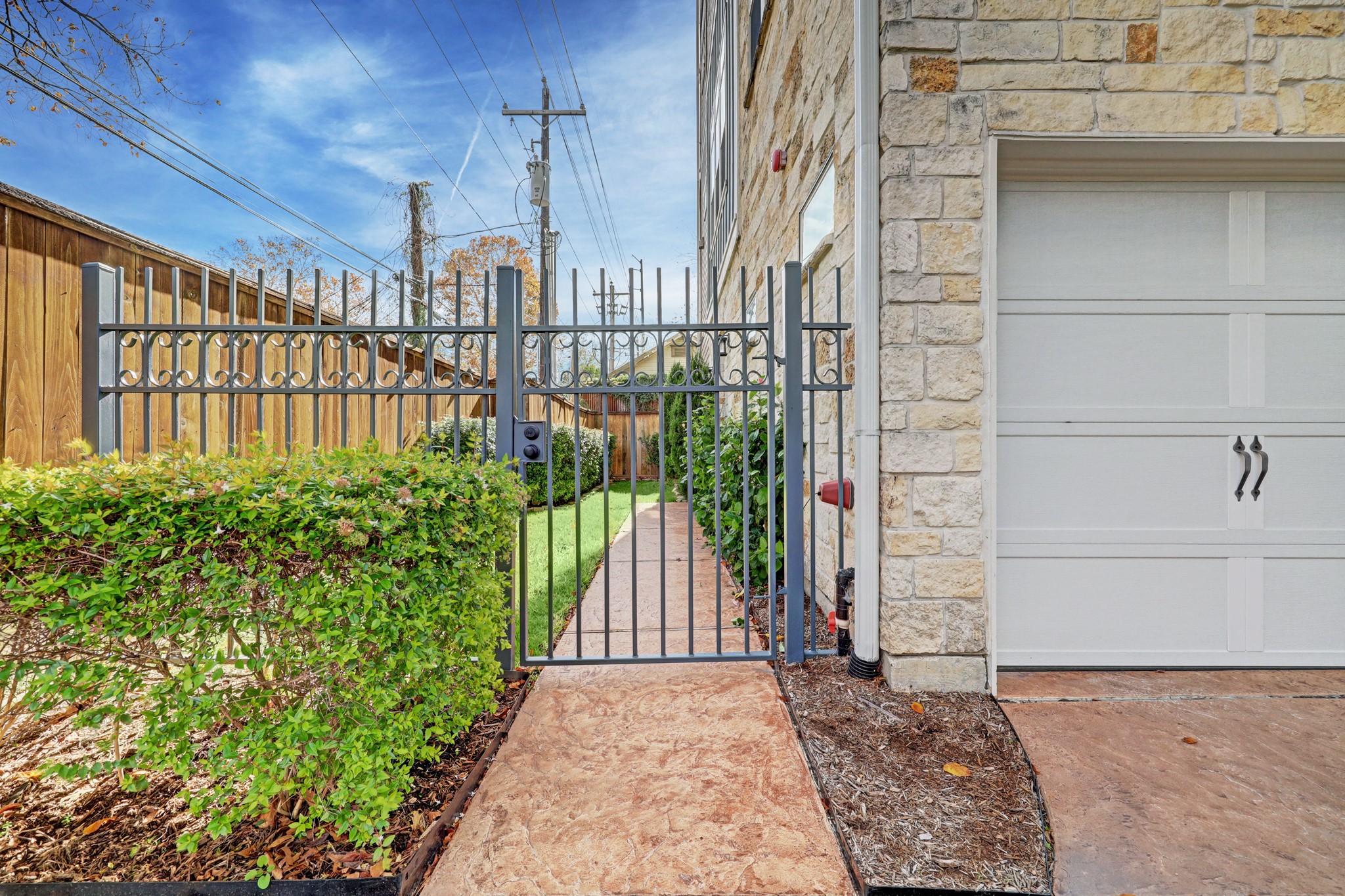 A security gate to home's side yard and front door.