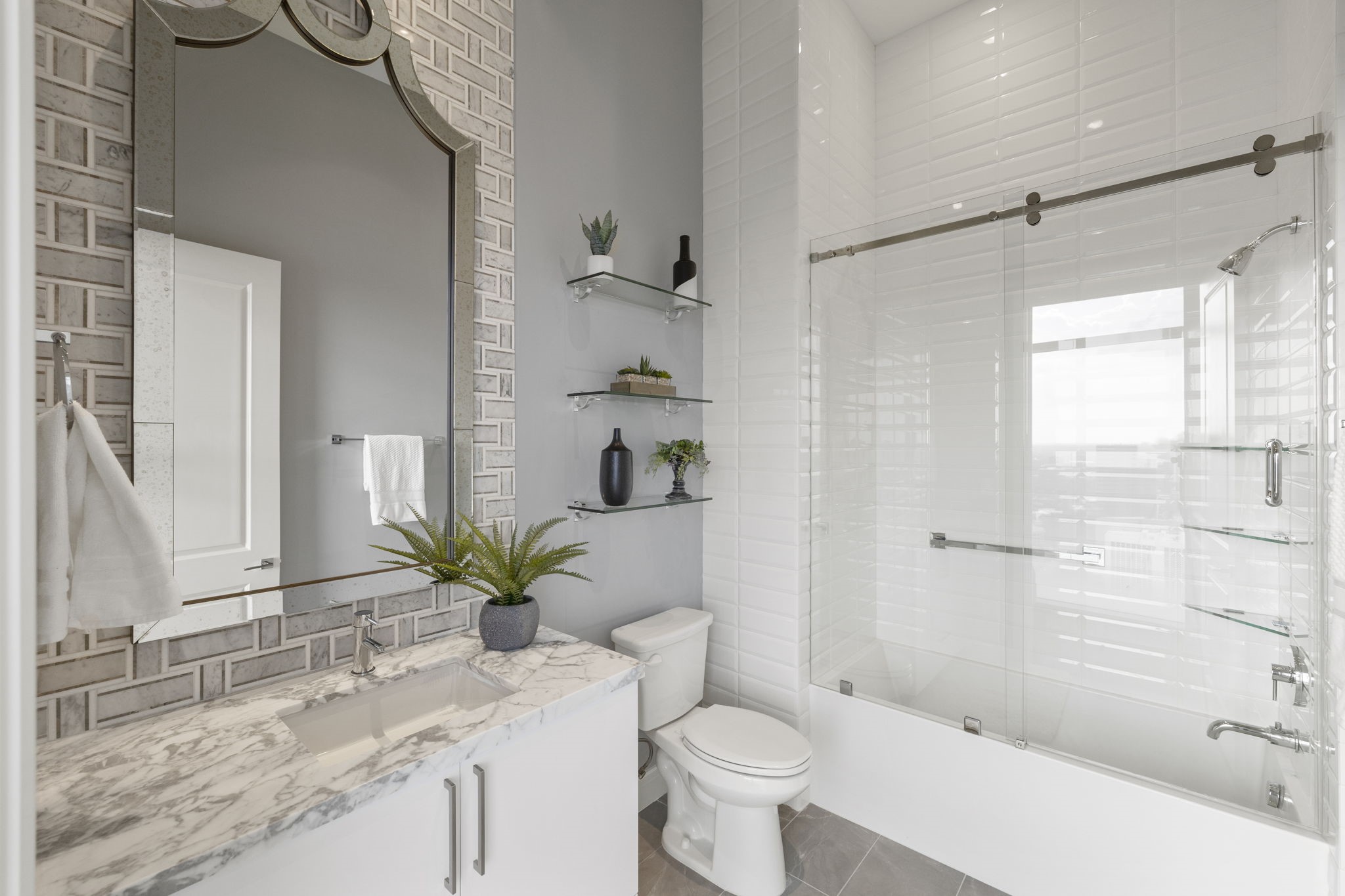 Welcome to a third en-suite bathroom that embodies both comfort and style. The tile floors and tub/shower combo with a tile surround make this space a functional and elegant addition to your home.