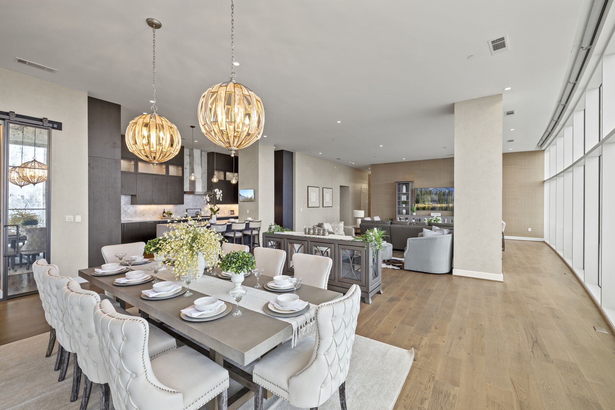The dining area dazzles with stunning chandeliers as the focal point.