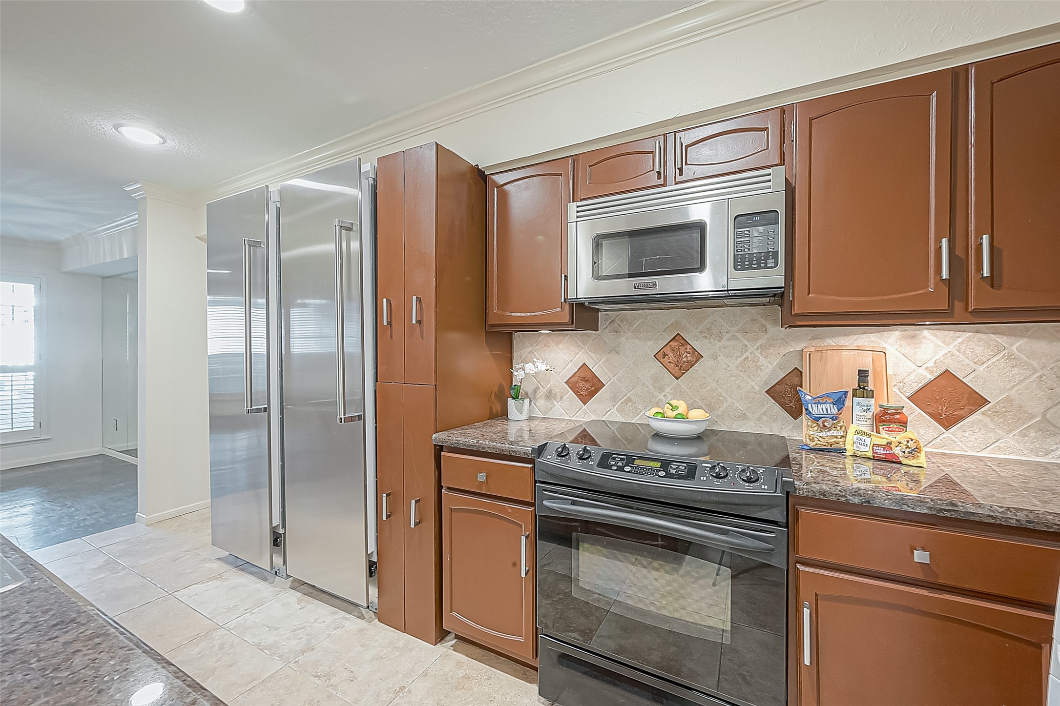 Kitchen has stainless steel Viking appliances with Sub-Zero refrigerator and freezer.