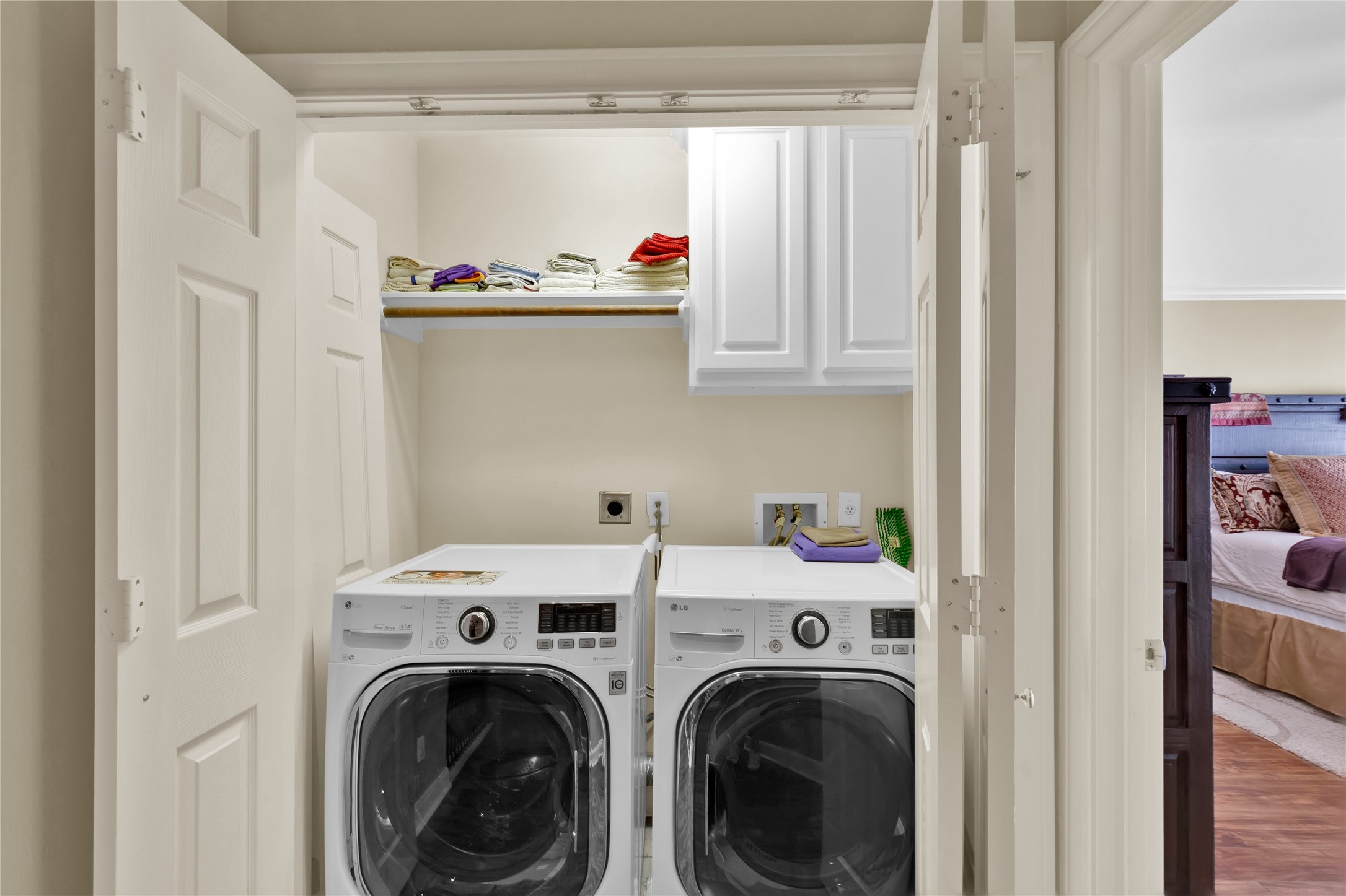 Laundry room nestled between the primary suite and the 3rd bedroom.