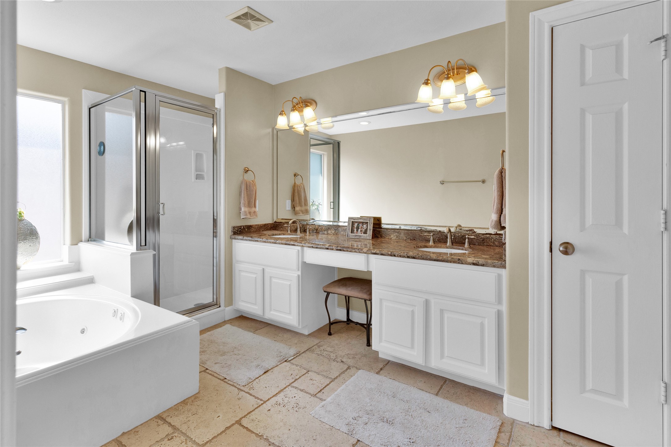 Primary bathroom has vanity, double sinks, soaking tub and a separate shower.