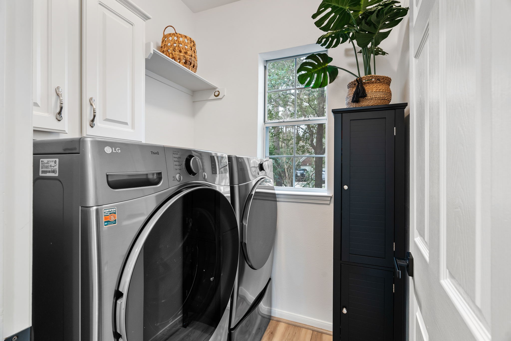 The laundry room is located just off the kitchen and has a window to the front.