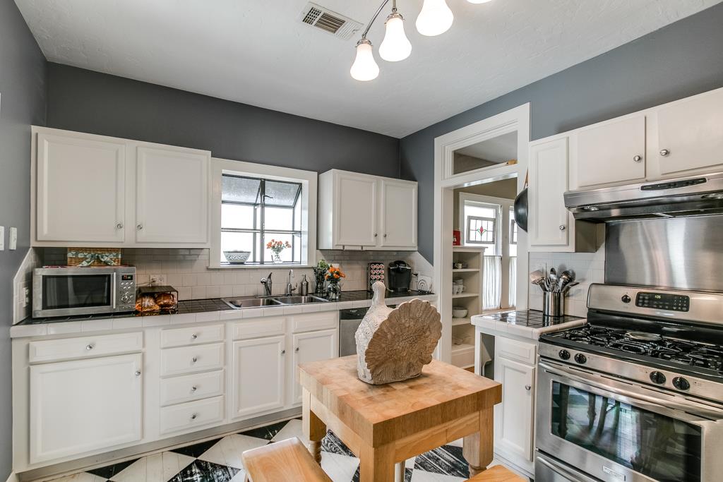 Kitchen boasts stainless appliances and ample cabinet space.