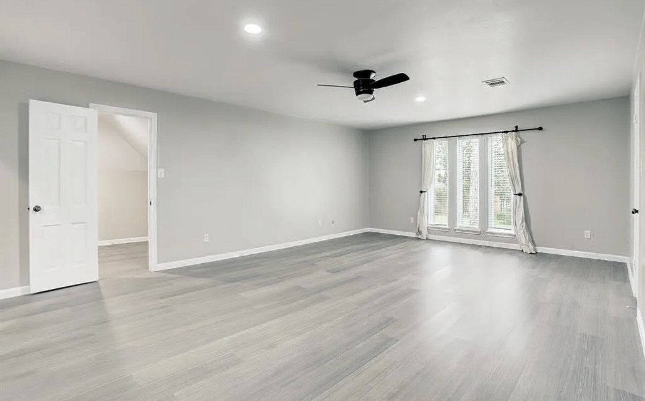 Welcome to your lovely primary suite! Features include luxe laminate flooring, designer paint, tall ceilings, recessed lights, a ceiling fan, bright windows, ensuite bathroom, and a massive walk-in closet.