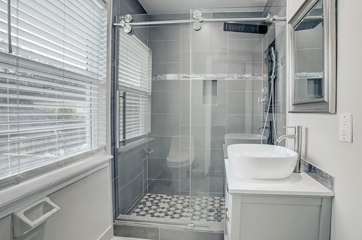 This secondary bathroom features an upgraded frameless walk-in shower with updated fixtures!