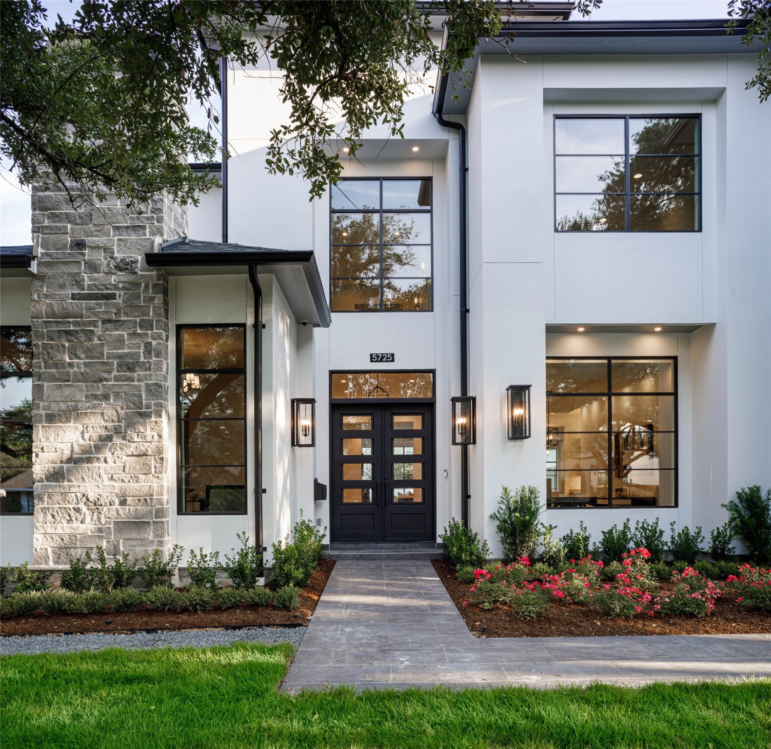 Inviting front elevation revealing extensive lush landscape and manicured grounds
