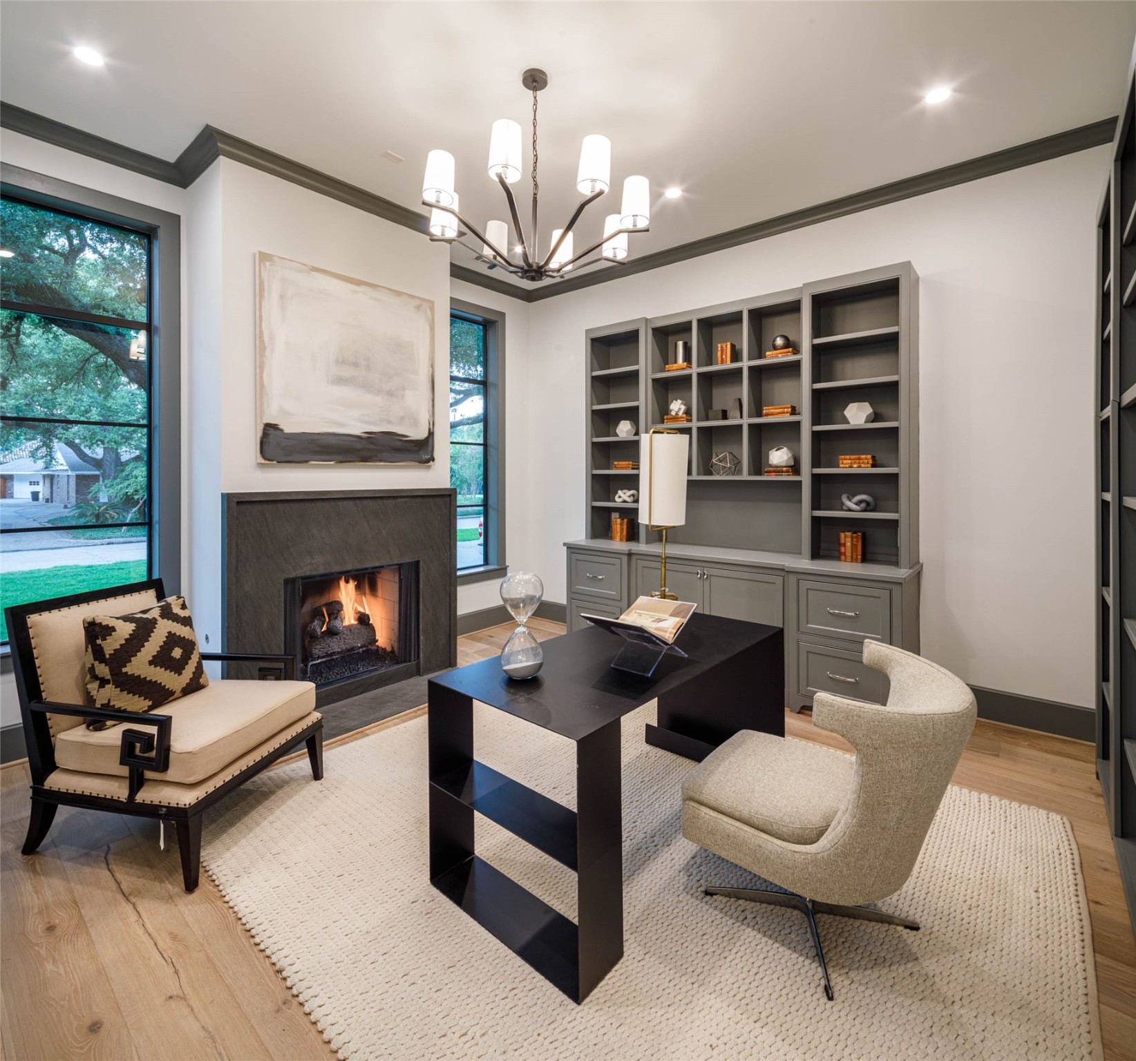 A beautifully designed functional and classy home office that will inspire your productivity.  Features fire place with marble mantle, built-in book cases, an integrated concealed walk-in closet and designer chandelier