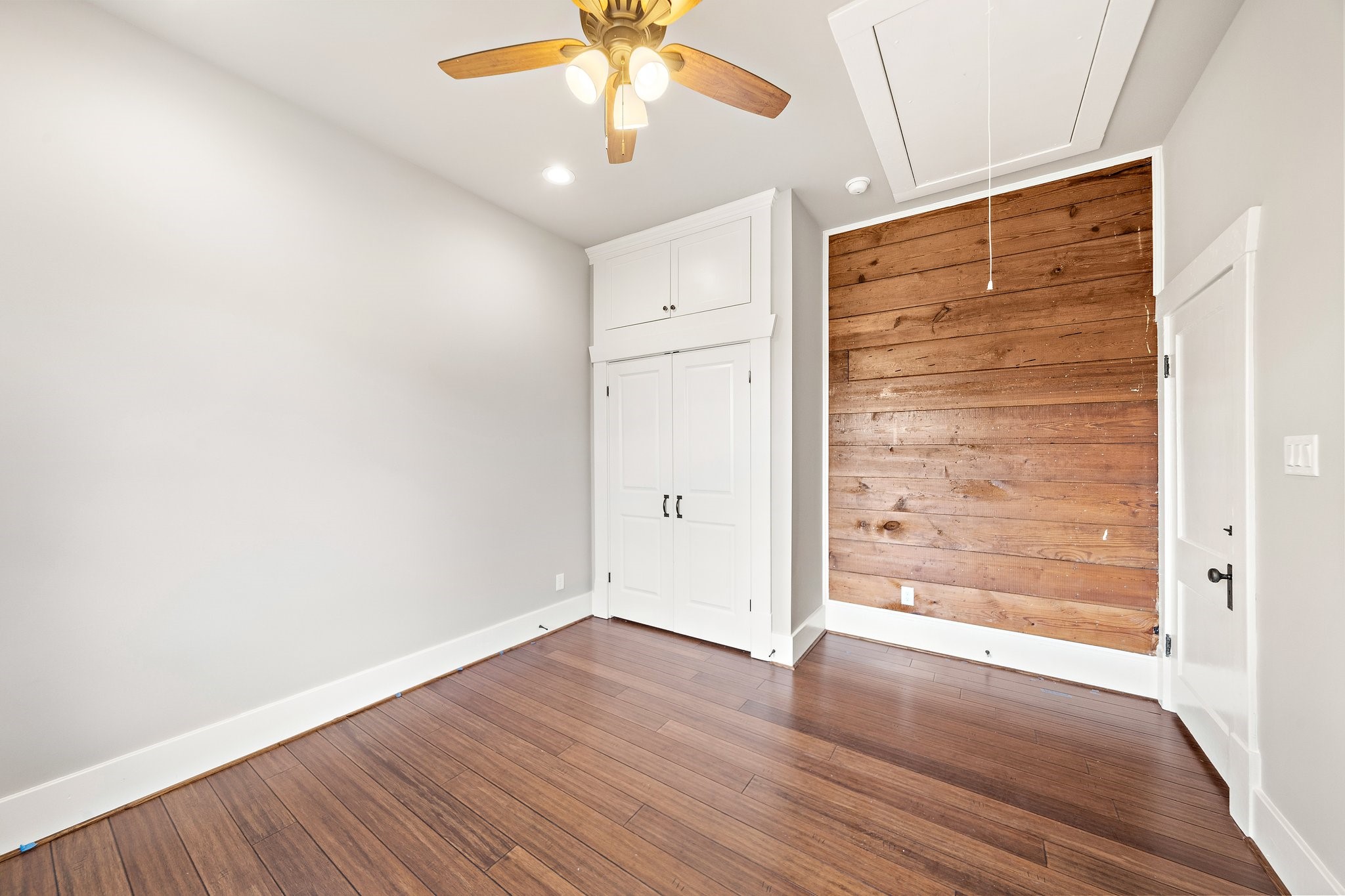 Double door storage and custom built cabinets to the ceiling! Exposed shiplap wall!