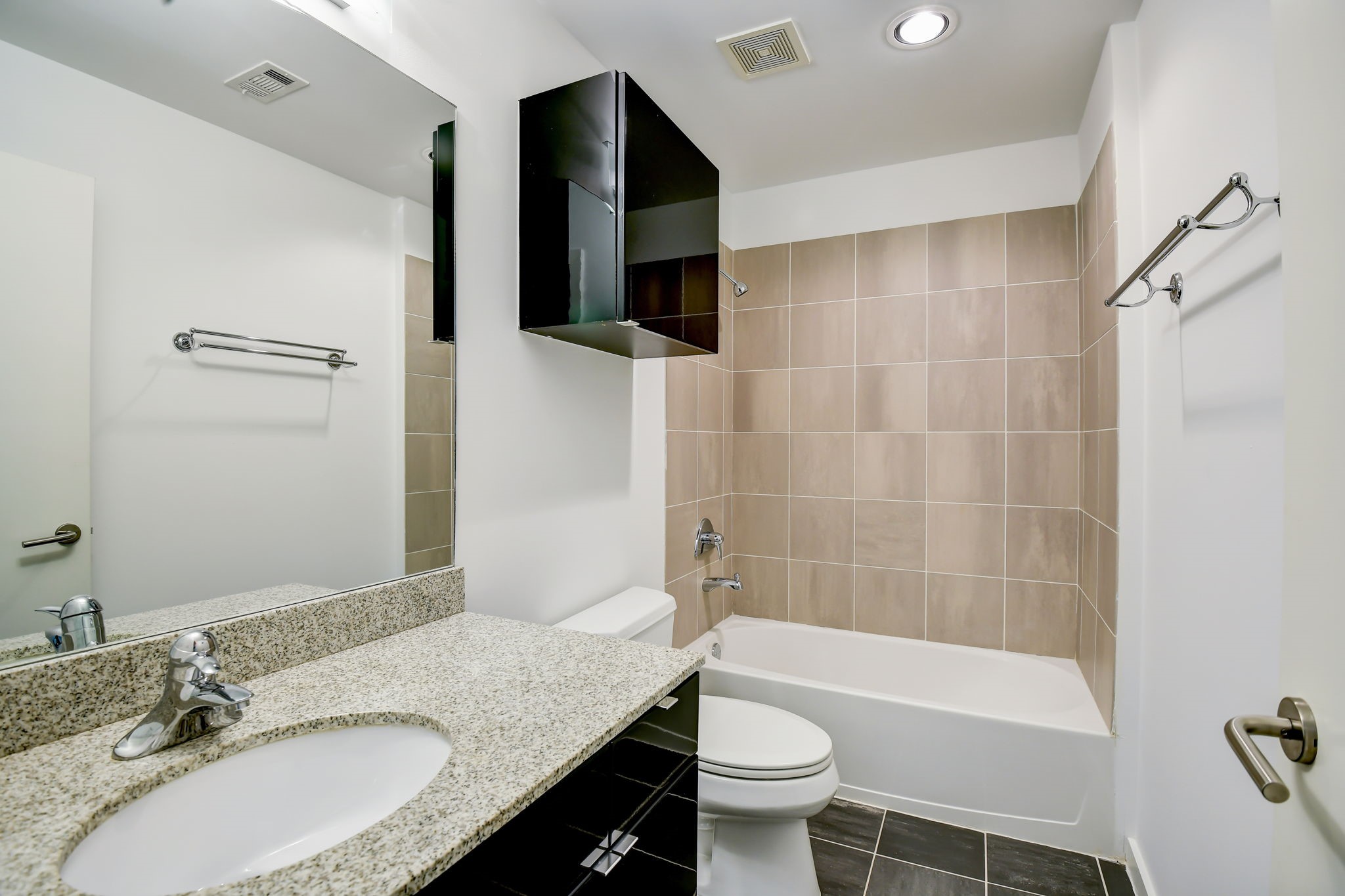 Spare bathroom has full bath/shower combo and granite countertops