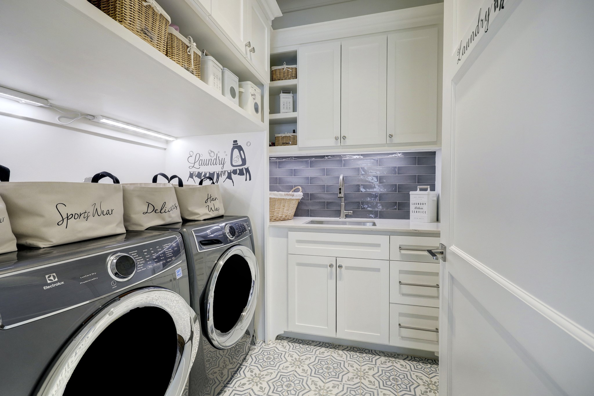 Centrally located, expansive laundry room with sink,
abundant storage, and
charming tile floor.