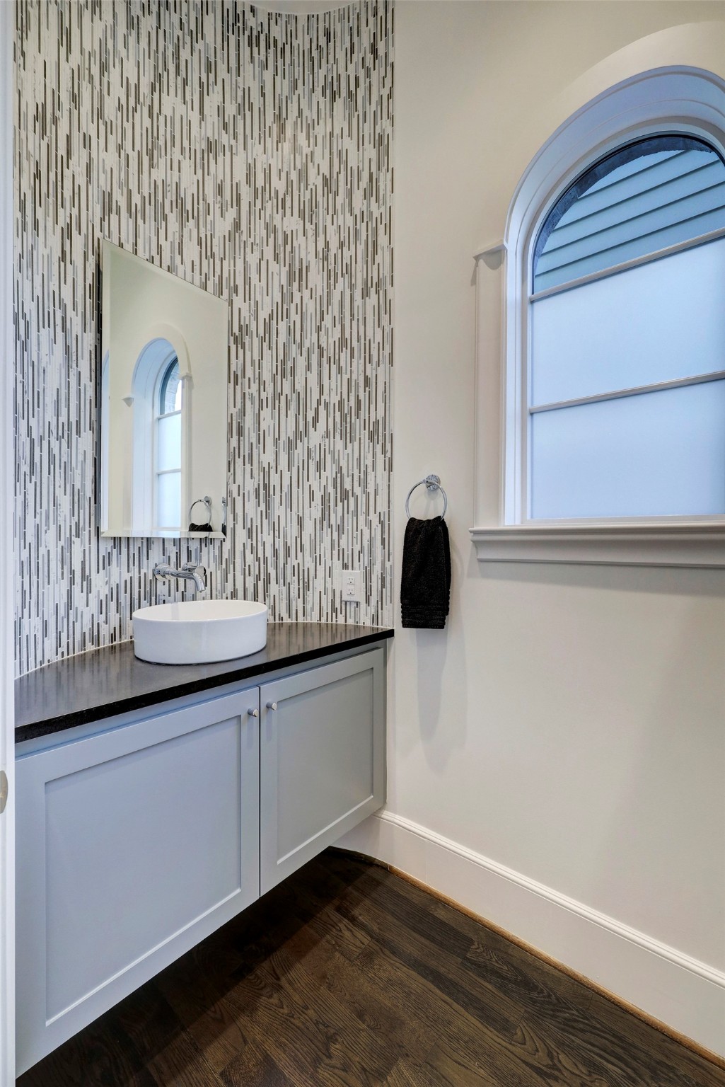 The curvature of the powder room marble backsplash is another example of the
sophistication of this home. Not shown is the Geberit European
luxury toilet, which is included.