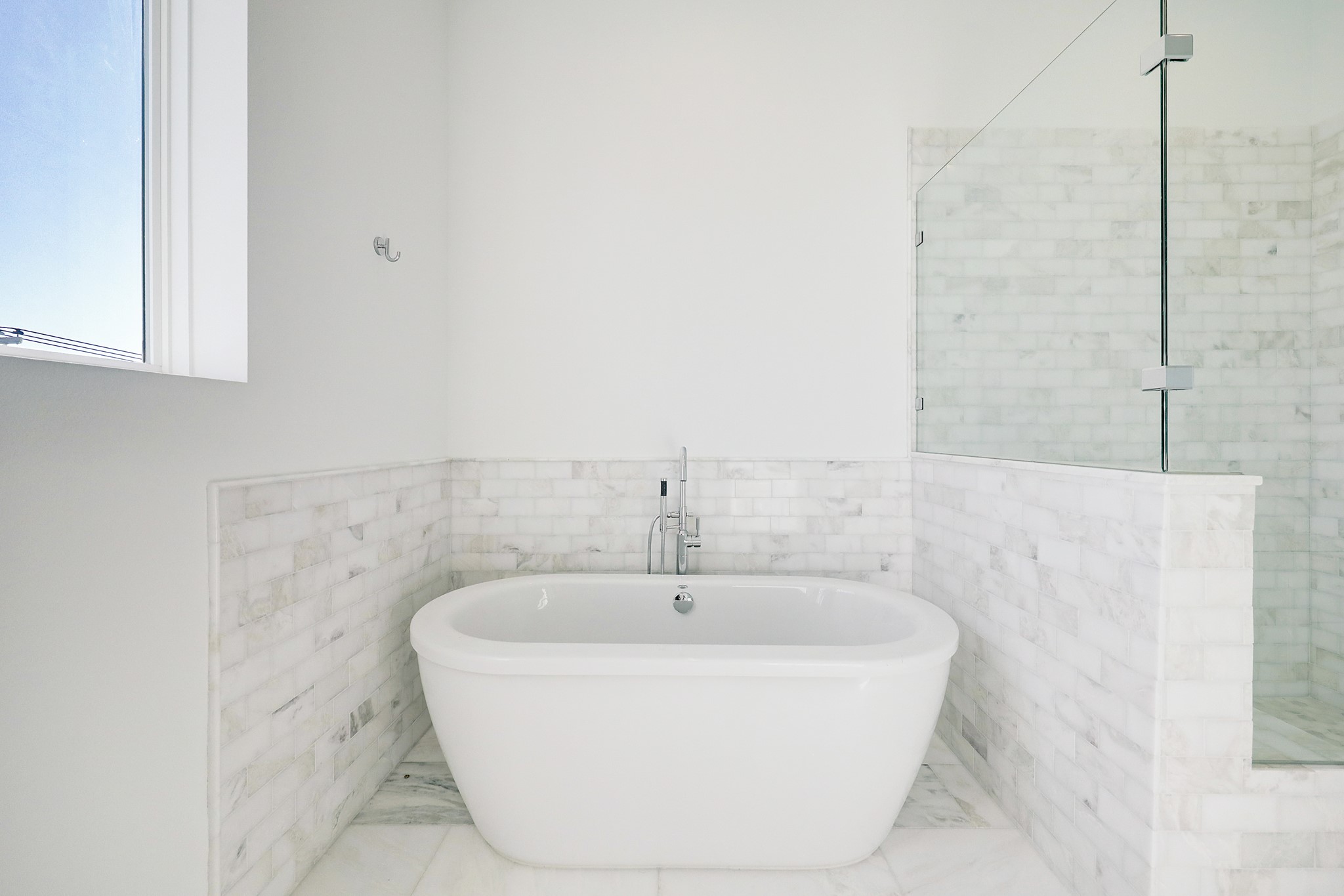 Free Standing Soaking Tub Surrounded by Marble.