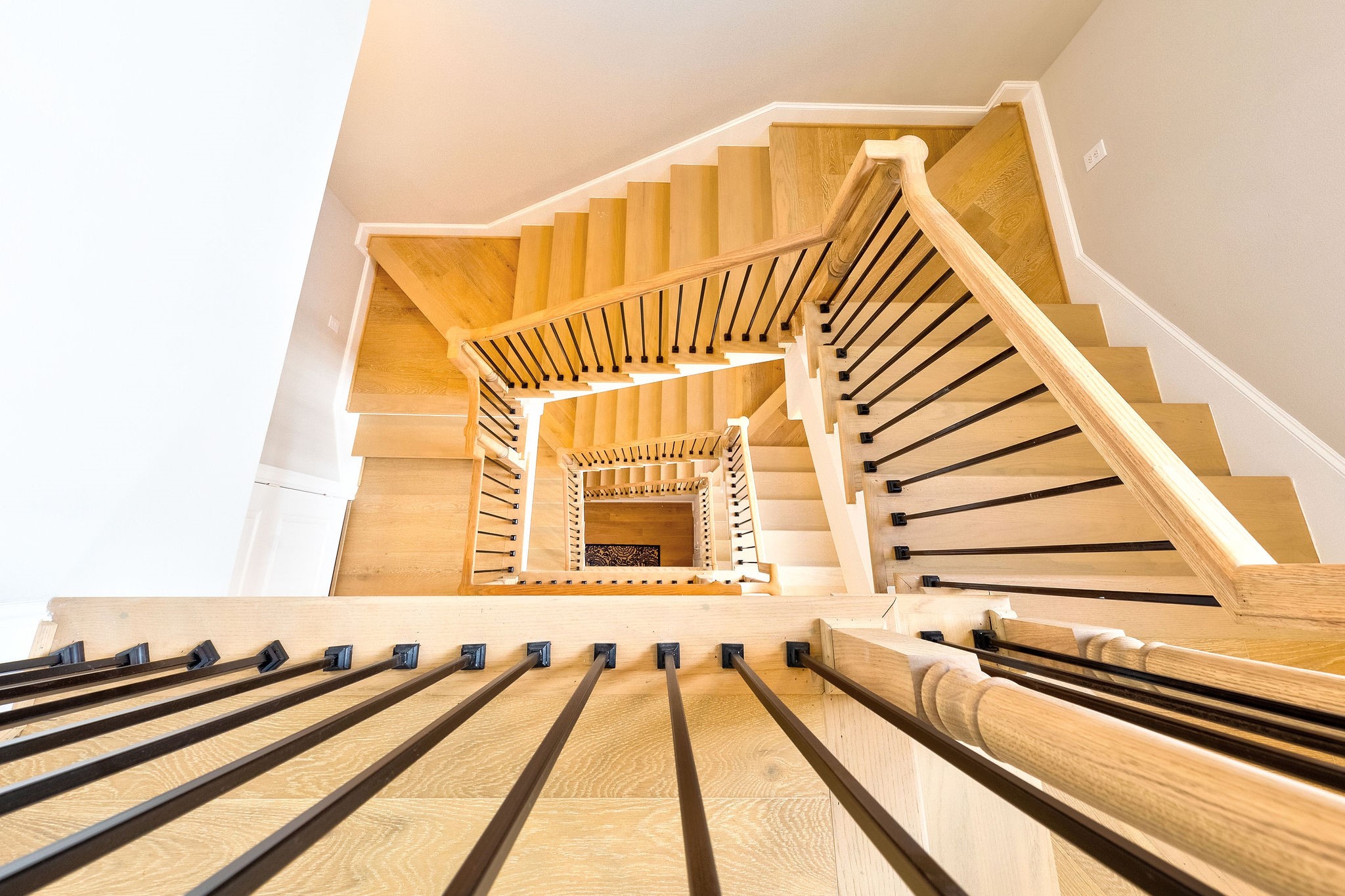 beautiful open staircase gives open airy and luxe feel to floorplan