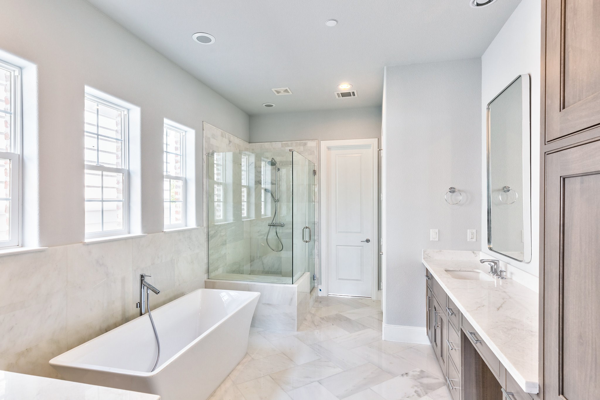 elegant upgraded primary bathroom with freestanding tub similar to this one