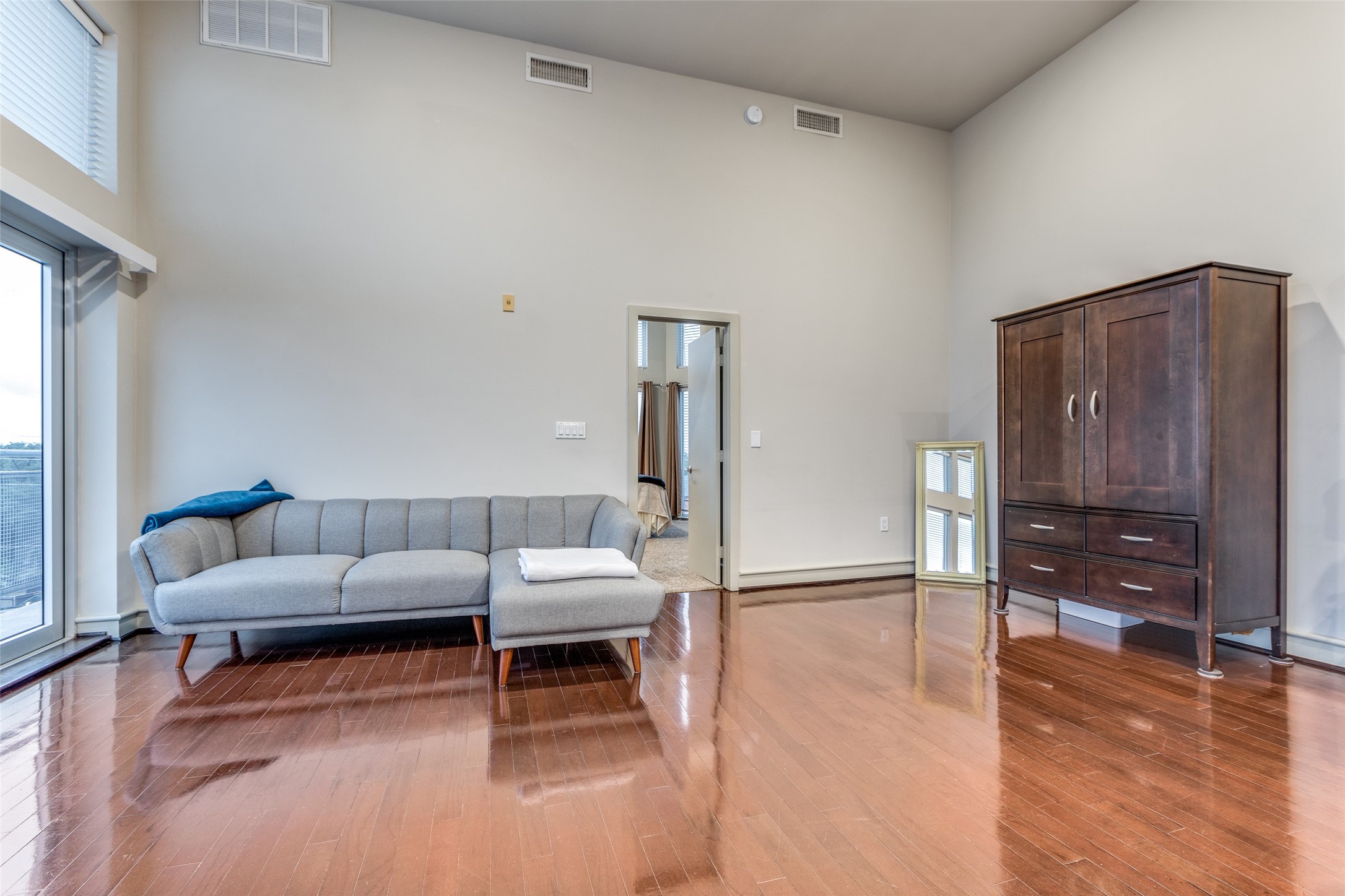 A retreat where the interplay of hardwood floors, natural light, and space creates an environment that is both aesthetically pleasing and functionally comfortable.