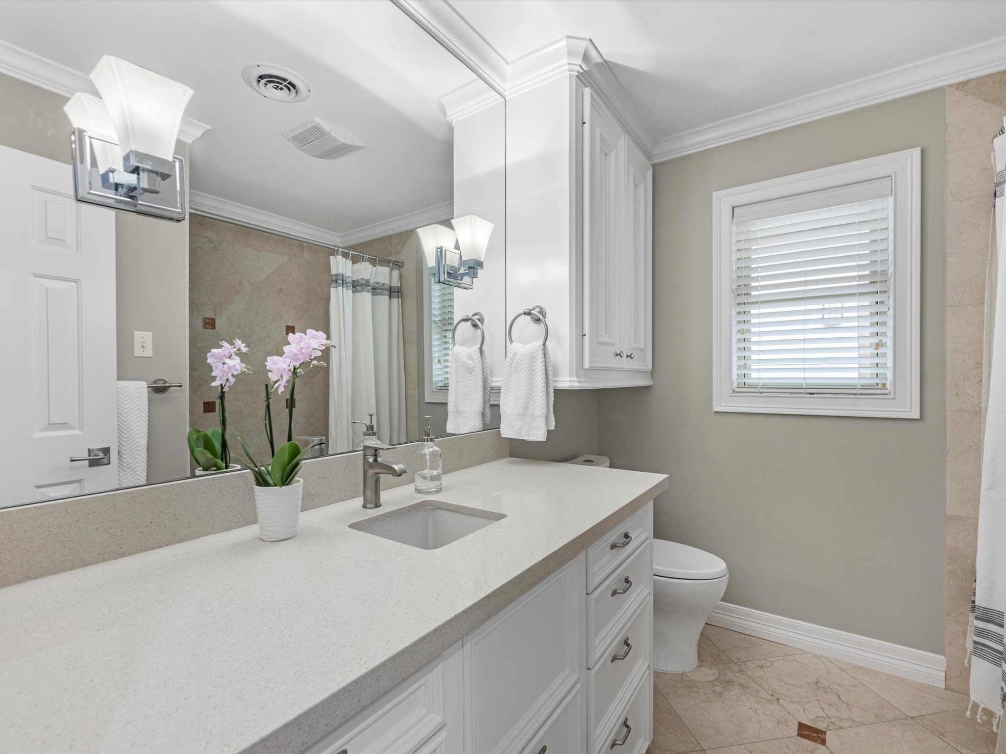 The third full bathroom is across the hall from the third bedroom, and has a tub/shower combo.