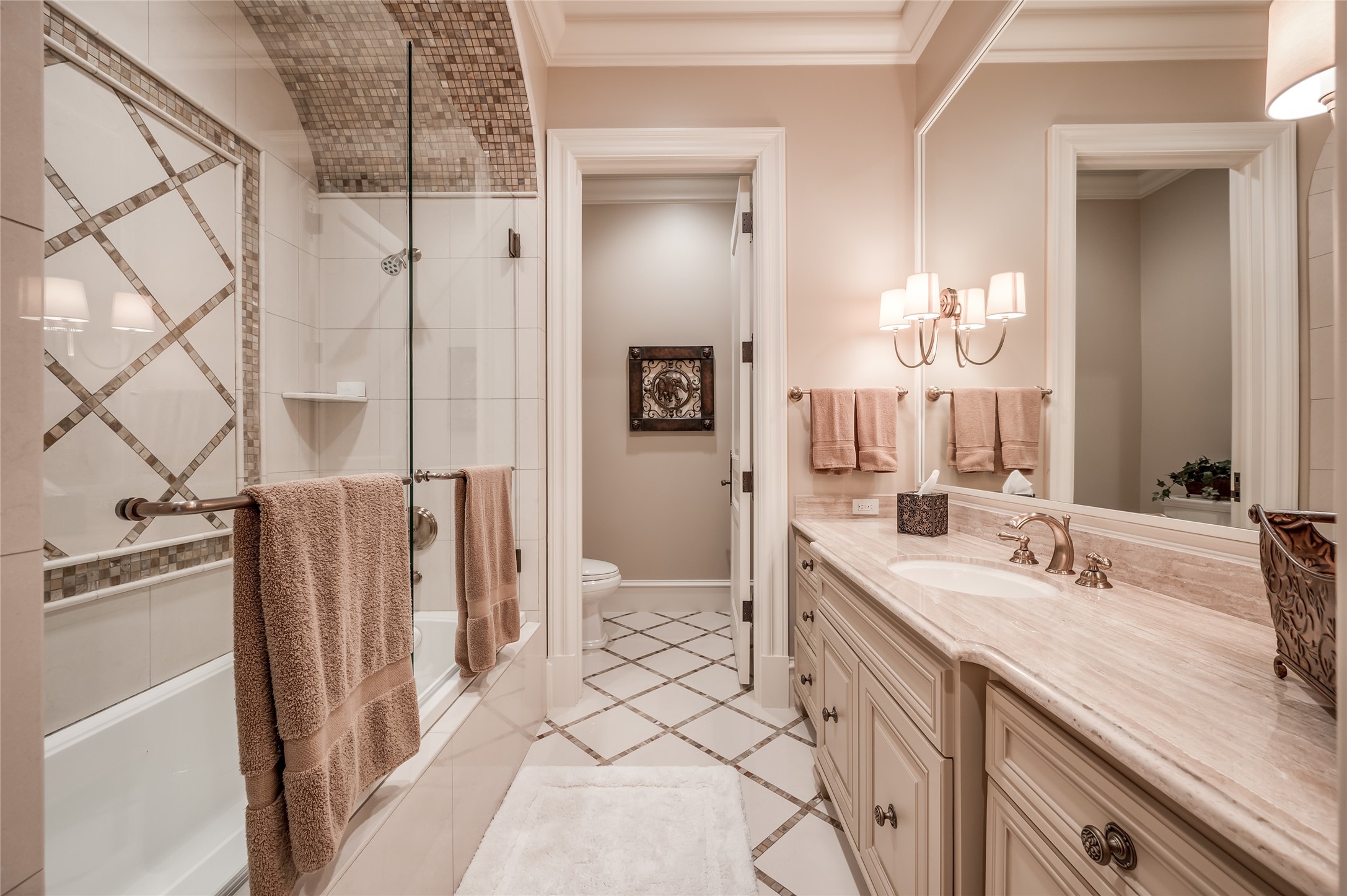 [En Suite Bath]
En suite bath with porcelain floor, marble sink deck, and glass-enclosed tub shower.