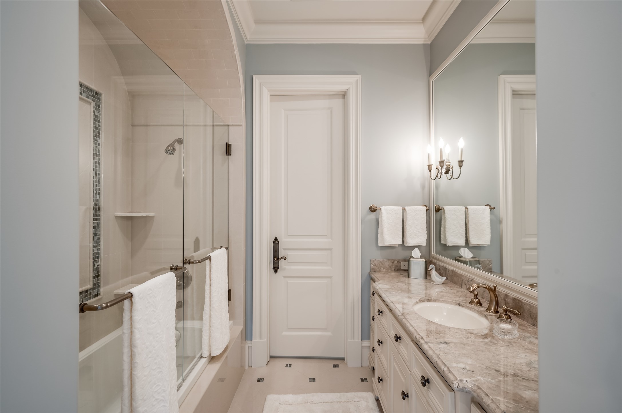 [En Suite Bath]
En suite bath with porcelain floor, marble sink deck, and glass-enclosed tub shower.