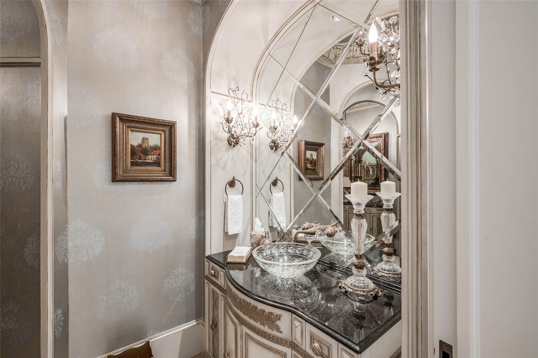 [Formal Powder Room]
The formal powder room has faux painted walls, a beveled, diamond-paneled mirror, and an etched glass vessel sink atop a bombe cabinet.