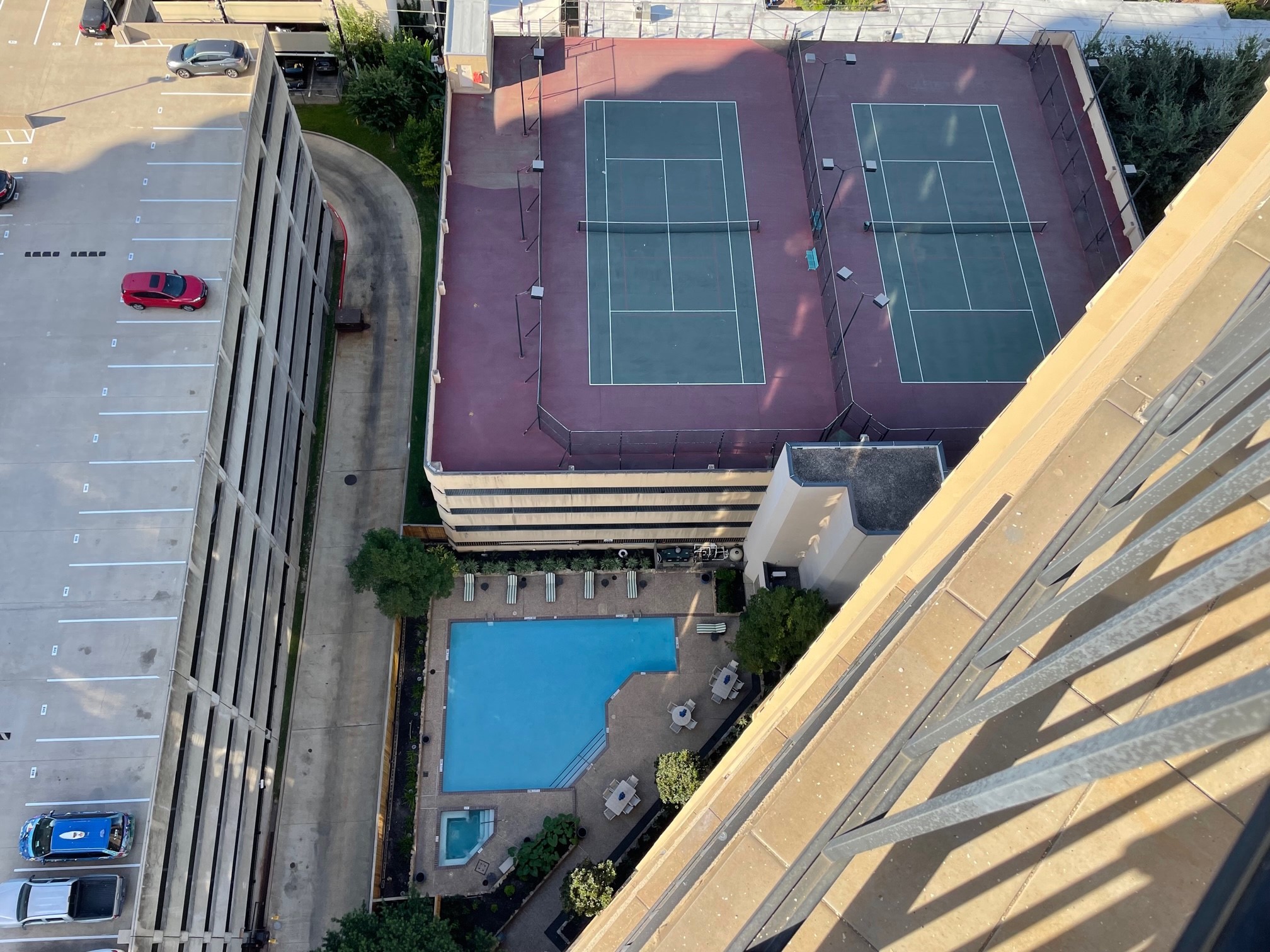 Pool, hot tub, 2 tennis courts on the roof of garage from the 21st floor