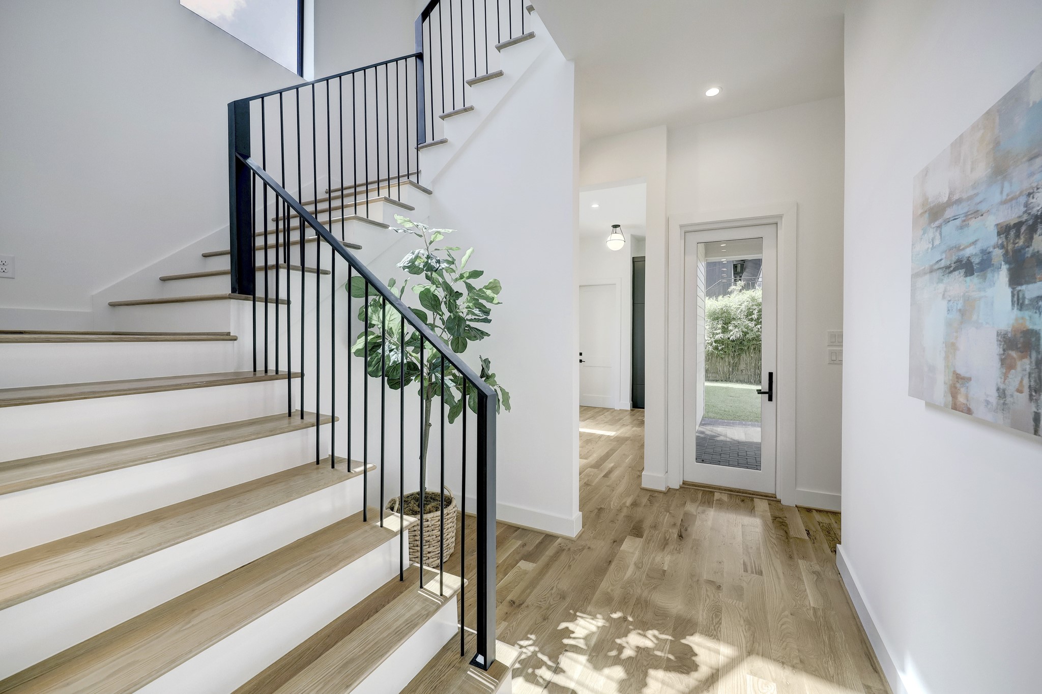 Gorgeous custom-stained natural white oak hardwood flooring throughout this stunning residence