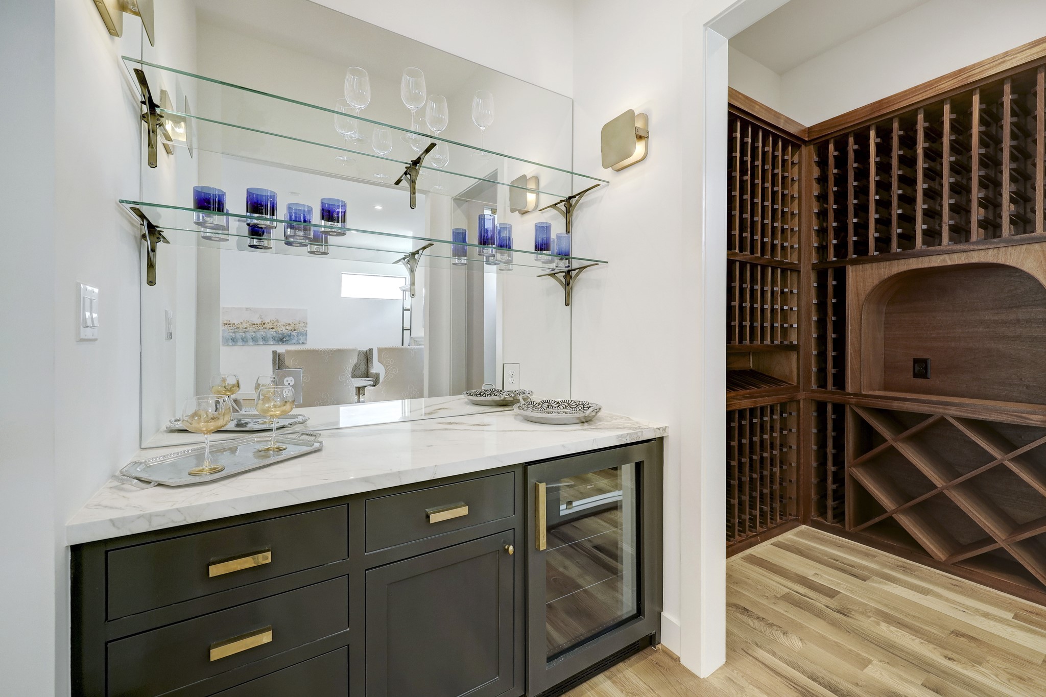 Dry bar and wine room off great room with beverage refrigerator. Custom-designed mahogany wine display and storage room with 200+ bottle capacity. Insulated separate HVAC zone control.