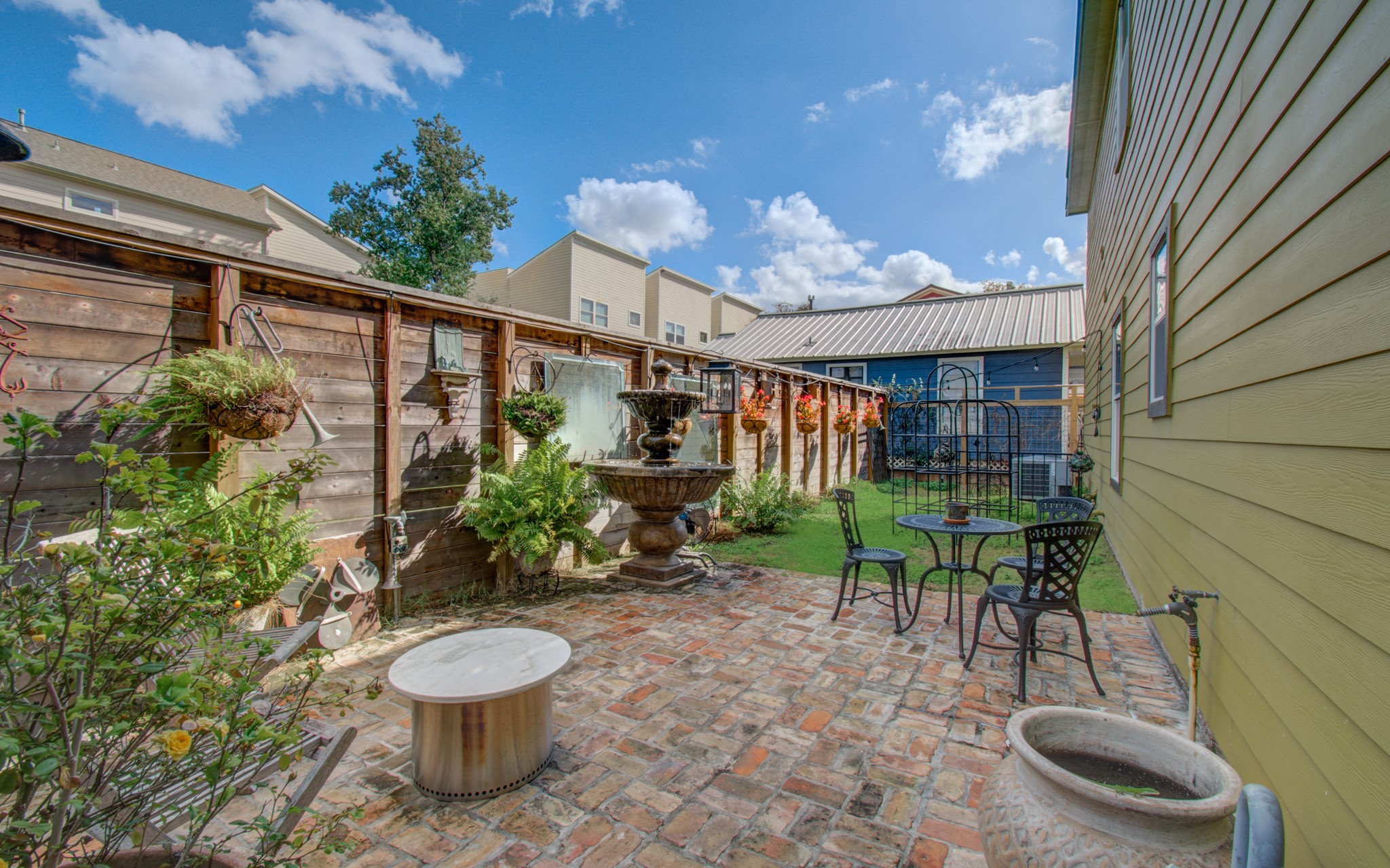 The owners expanded their outdoor living space by acquiring a 10x65 ft section of the adjacent lot, creating a serene side patio for added tranquility and enjoyment.